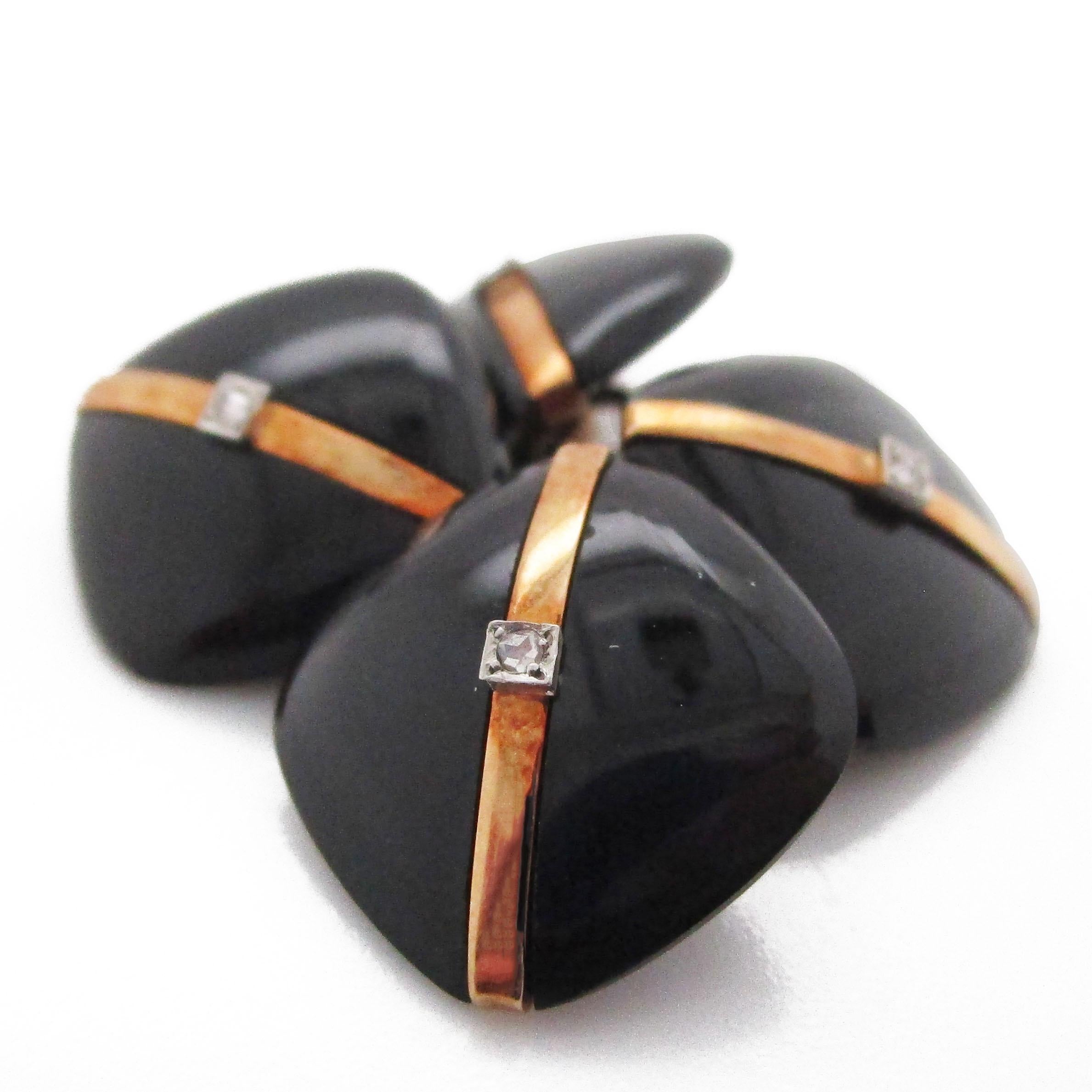 These cufflinks are from 1925 and are Art Deco through and through - as evidence by the stunning combination of rich black onyx, 14k rose gold, and rose cut diamond accents. The rounded square layout is perfected by the dimensional nature of the