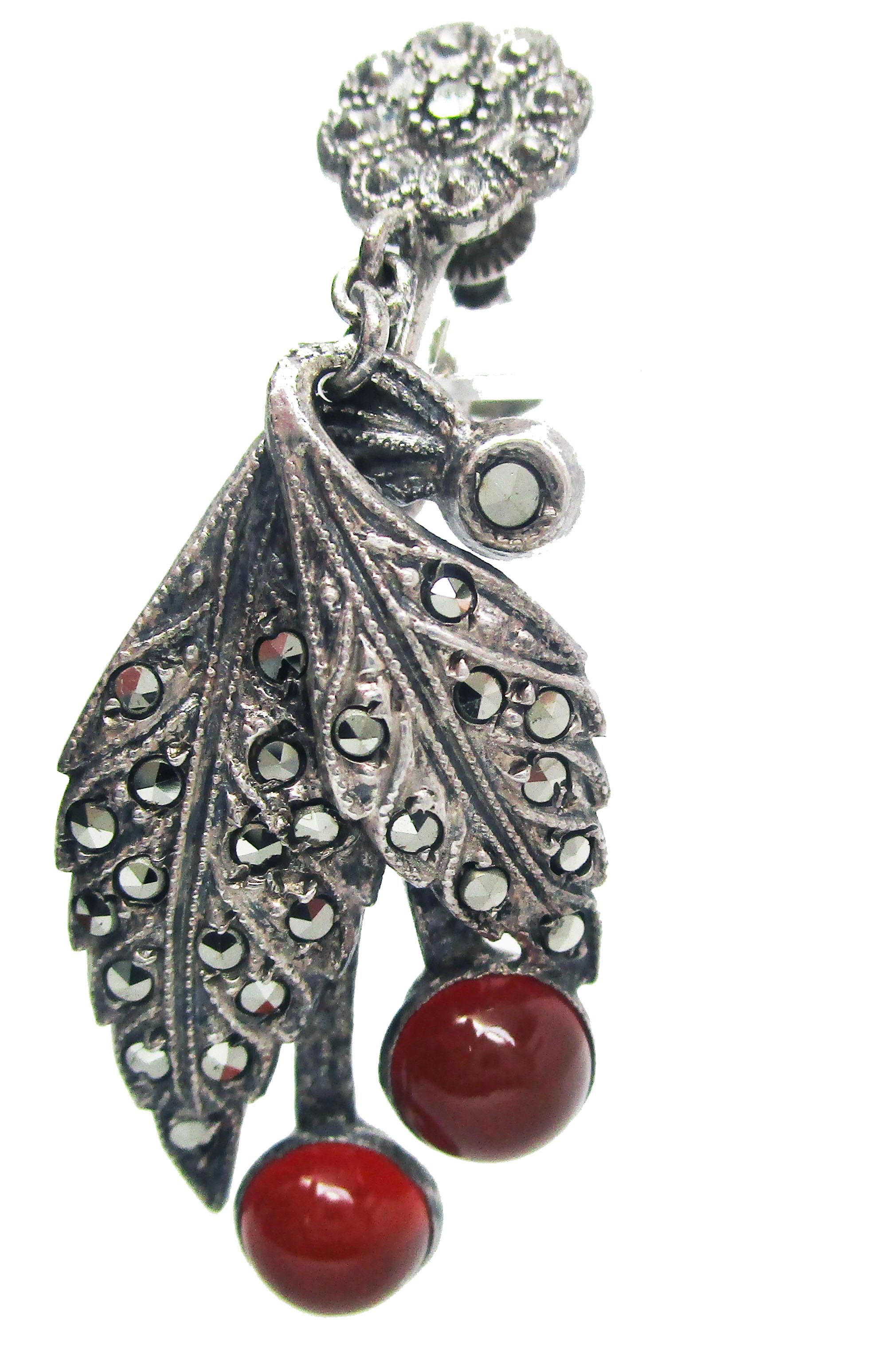 This is a fantastic pair of original Art Deco earrings in sterling silver featuring bright marcasite and rich, amber-hued carnelian! The Art Deco influence is clear in the dramatic lines and intense color contrast of these earrings. The sterling