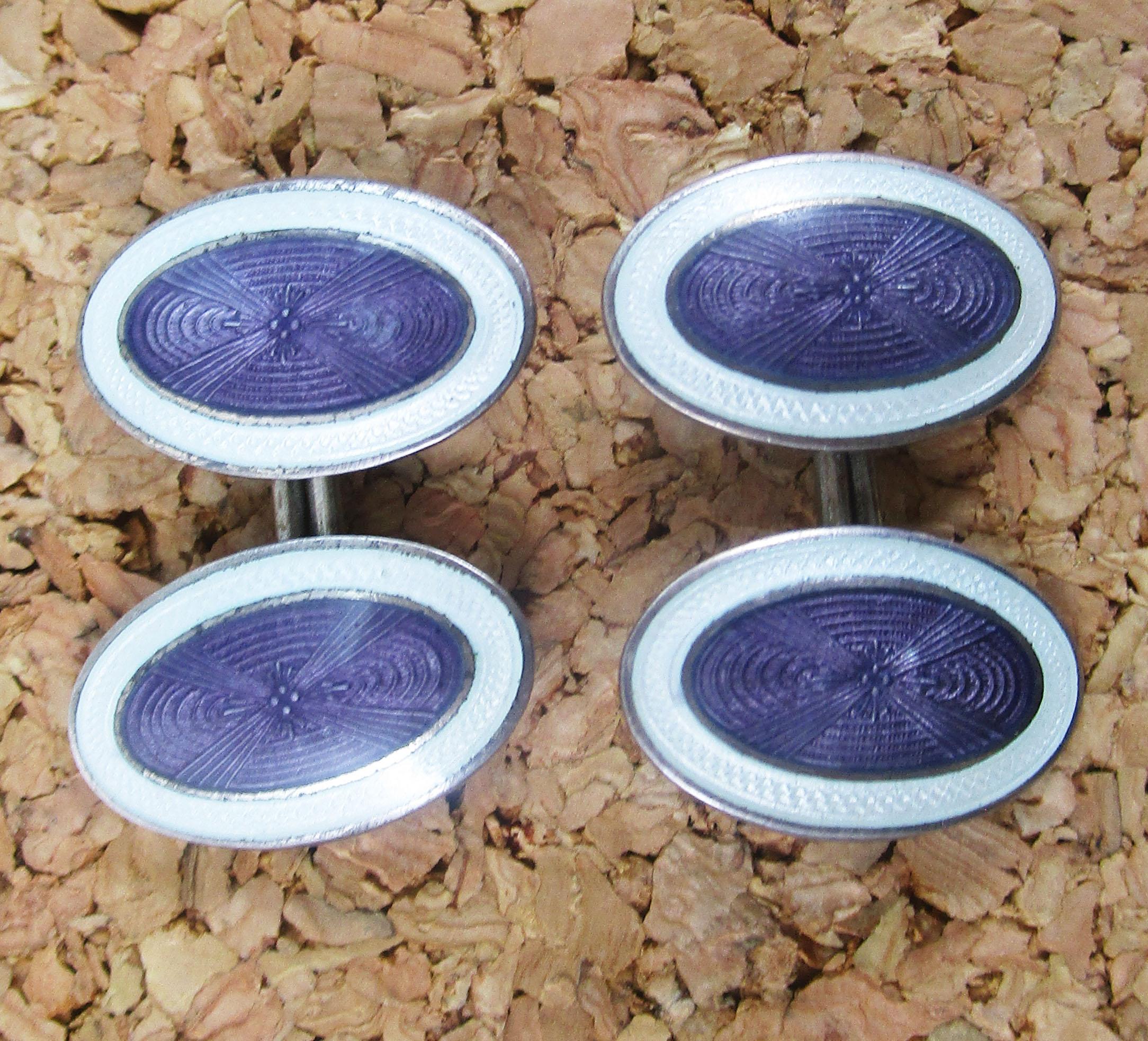 These elegant cufflinks are in sterling silver and have a distinctly Art Deco look completed by the dramatic combination of white and dusty purple enamel. The links have an elongated oval design that makes it easy to put the links on and take them