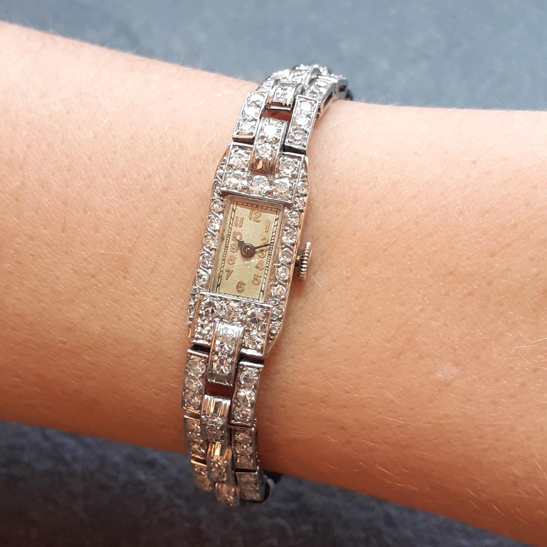 This very pretty Art deco lady watch is made of platinum. Each element is paved with old single cut diamonds. It's in excellent conditions and the mechanic movement works well. There is an approximate total carat weight of 2.5ct.  It is controlled