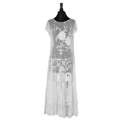 1925's  white lace dress on a tulle base with one ruffle in the bottom 