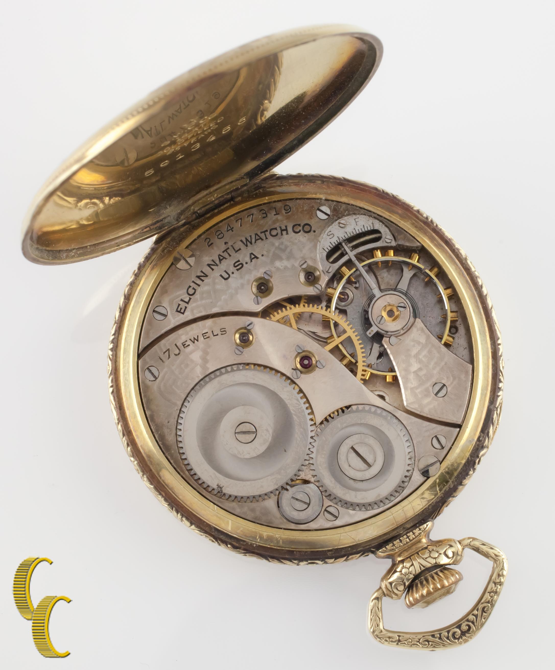 Beautiful antique Elgin pocket watch with champagne colored dial.
Blue hands and a dedicated seconds dial.
Gold-filled case with intricate hand-etched design on case and initials 
