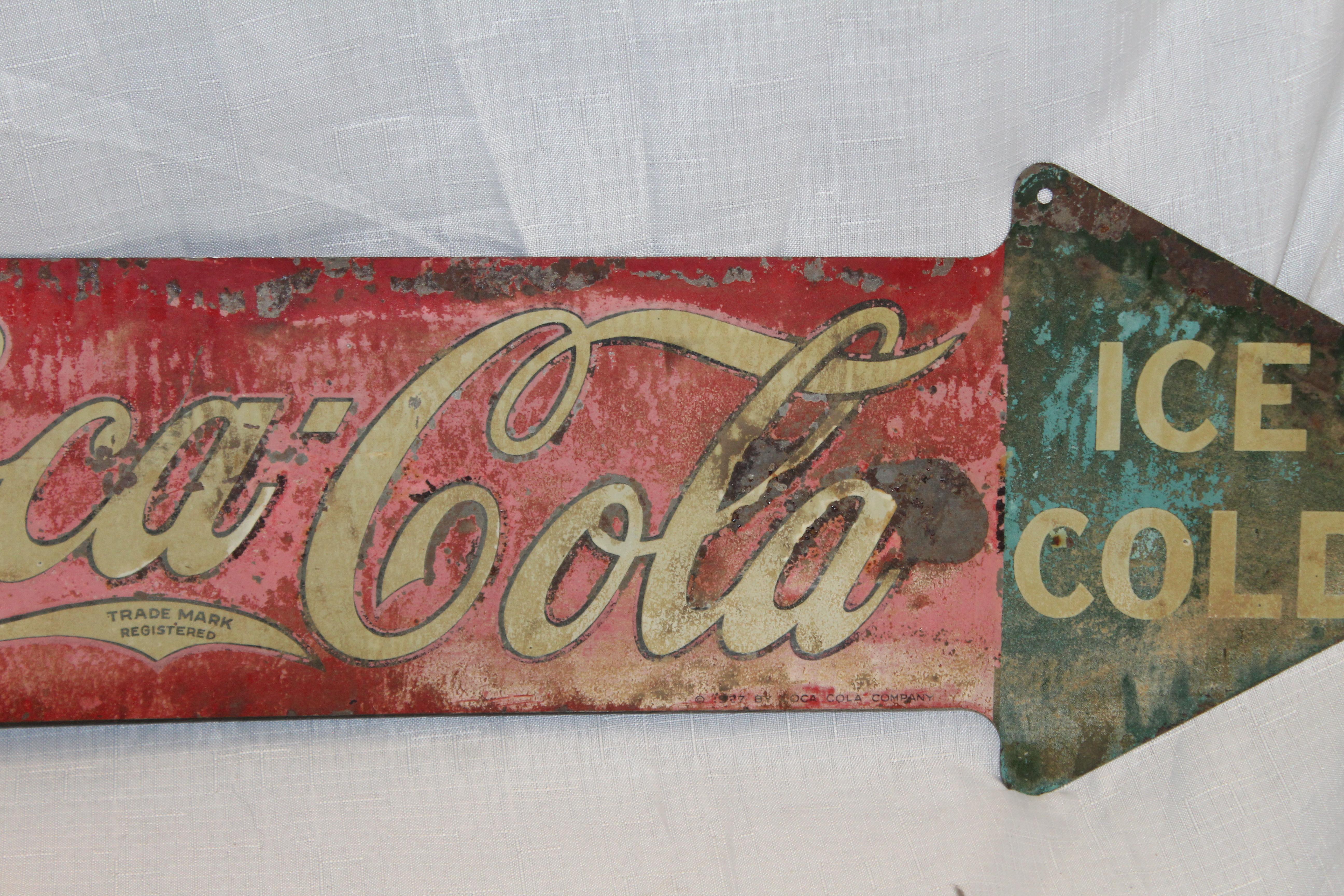 coca cola arrow sign
