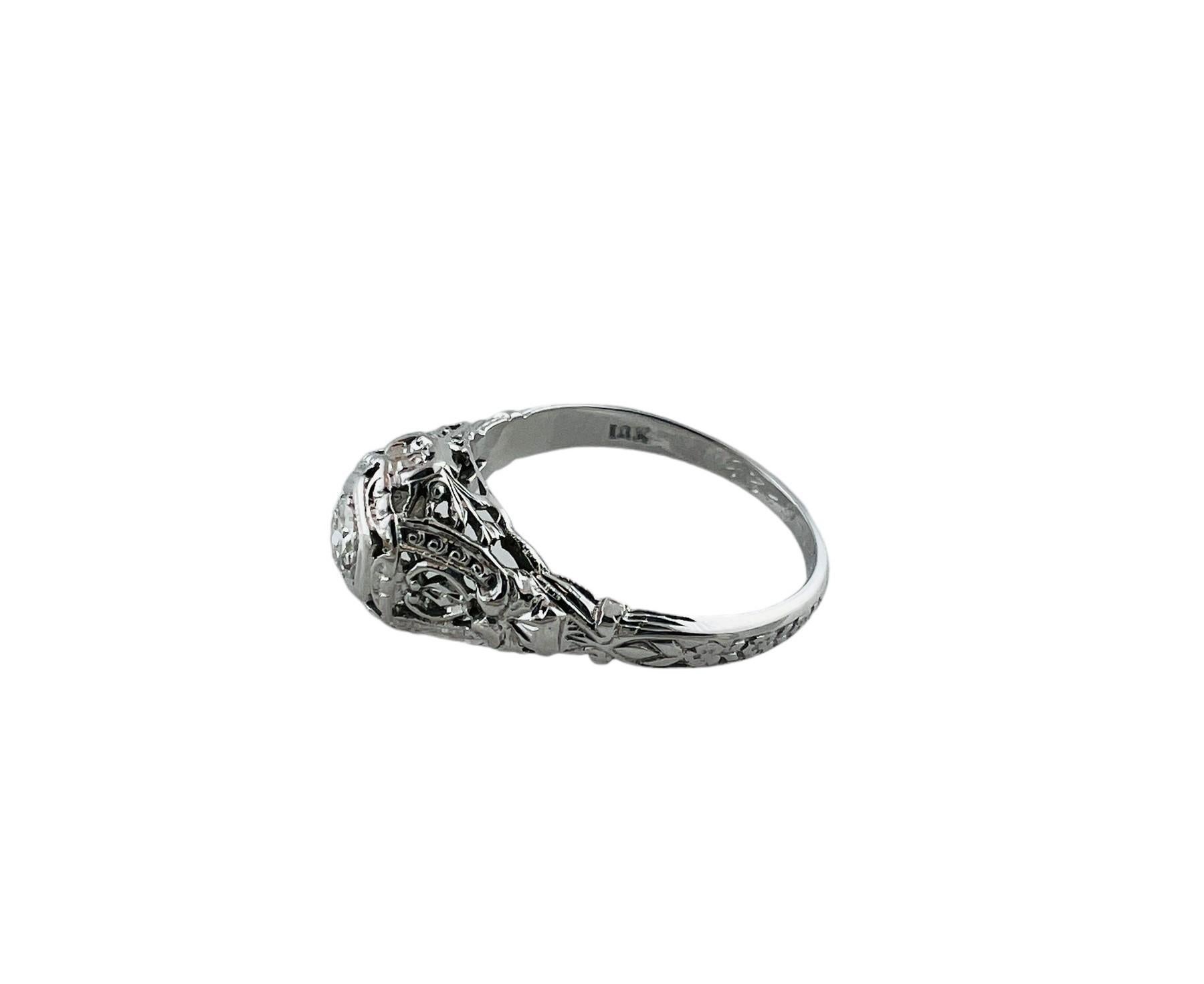 1928 18K White Gold Diamond Filigree Engagement Ring

This beautiful filigree style engagement ring is set in 18K white gold

Inside the ring is engraved W.J.D to ELL 10-6-28

Diamond is a round brilliant stone approx. 0.20 cts

Diamond clarity -