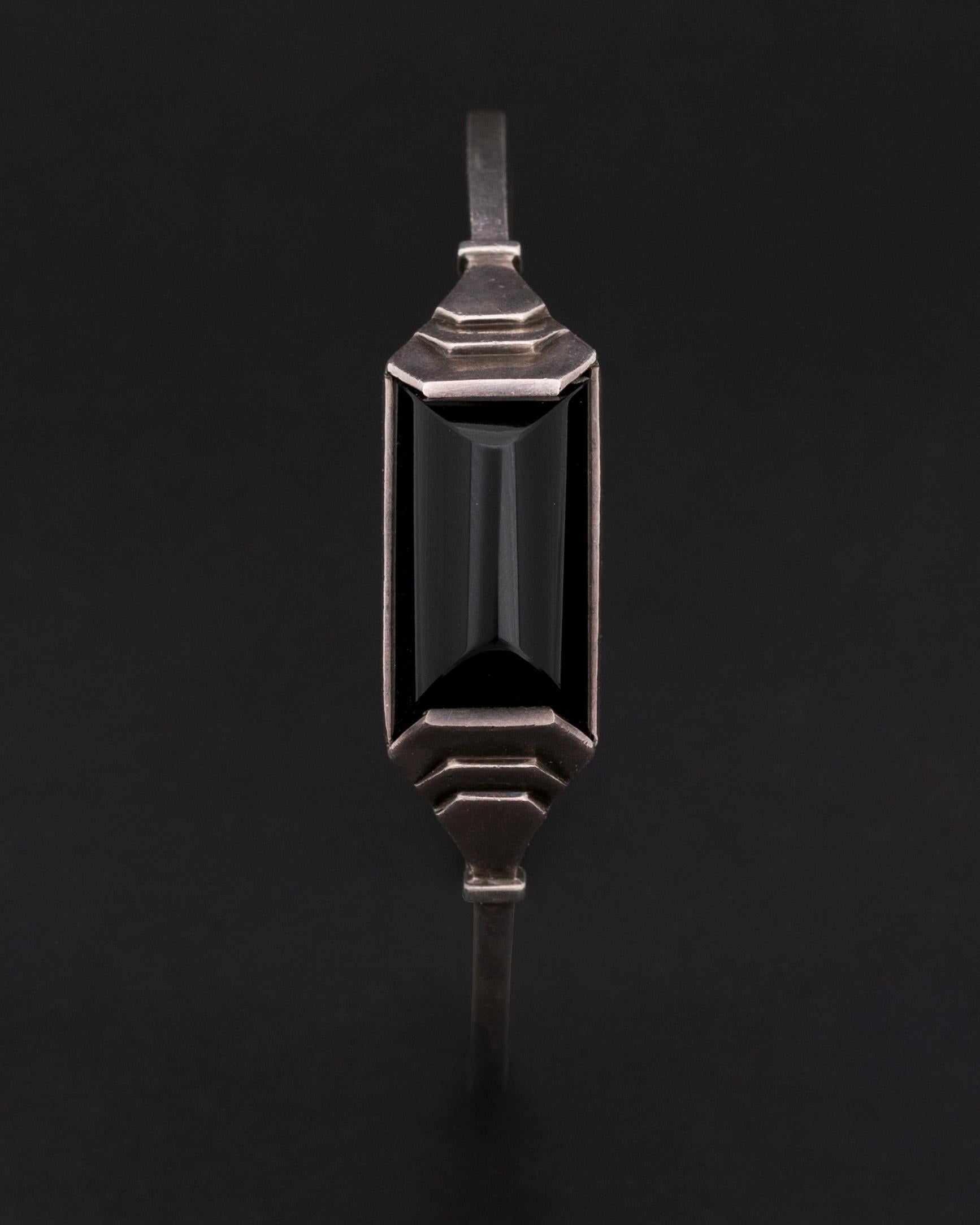 Express Shipping still available during Lockdown

Jean Despres,
Rare Art Deco Silver (Marked) and Onyx Bracelet created in 1928
The signature engraved under the dome (Image 5) and wears the poinçon d’orfèvre ‘JD’
 Inner Circumference : 185mm
Very