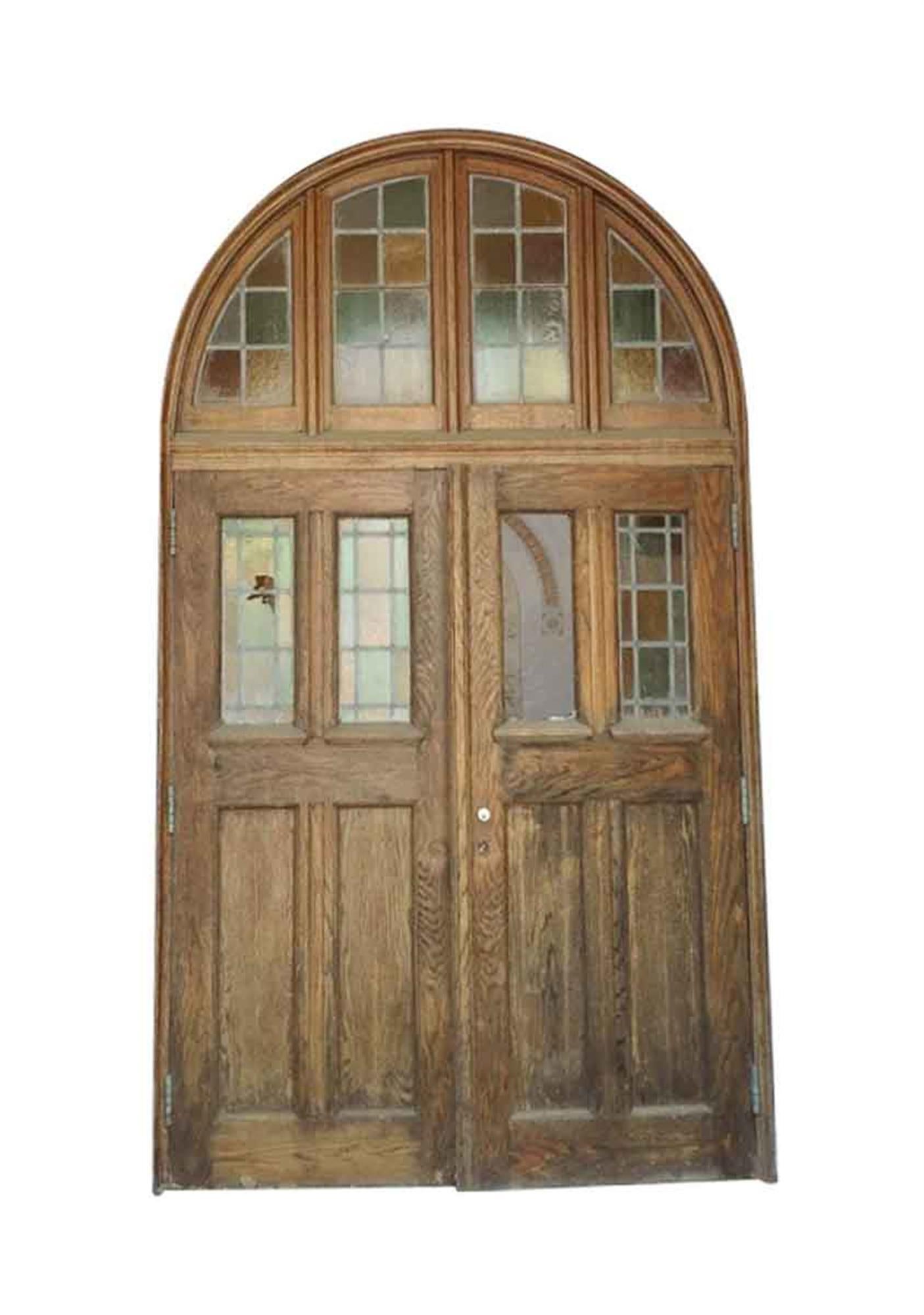 This is the entrance to the chapel from Rose Hill, the Tudor Mansion of American impresario Billy Rose. The doors and surround are oak with pastel stained glass that projects a subtle hue of light. Two panes of glass are broken. Price includes