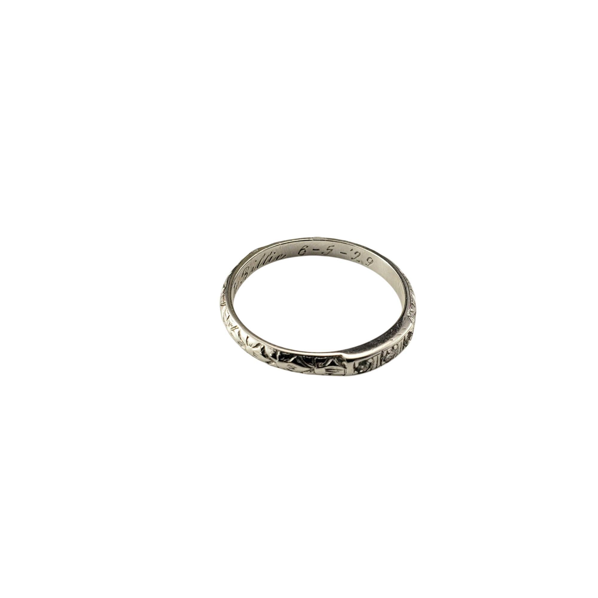 1929 Antique 18 Karat White Gold and Diamond Band Ring Size 6

Delicate and beautifully detailed, this antique 14K white gold band features three sparkling diamonds* set within an intricately engraved floral motif. The romantic design, paired with