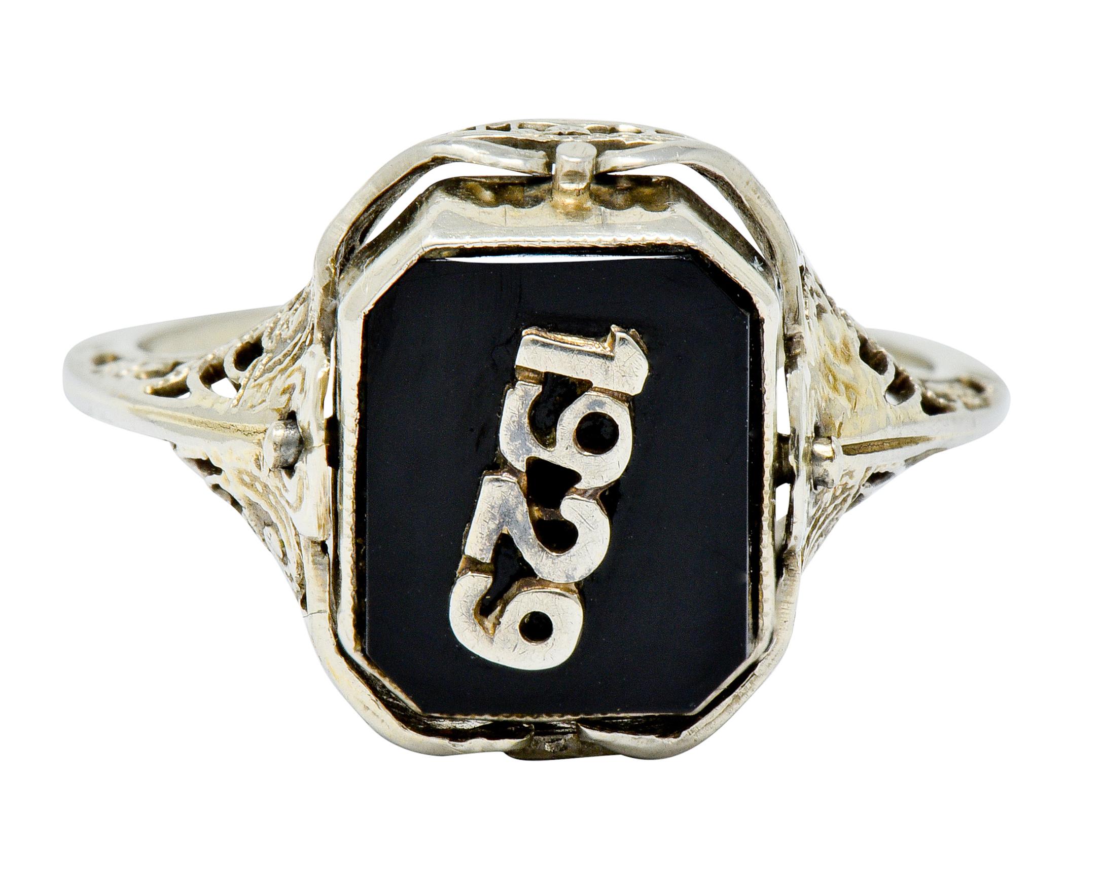 Designed as a flip stye ring, with one side a hardstone cameo depicting the carved profile of a woman

Reversed by an onyx tablet centering stylized platinum numerals '1929'

Each bezel set with miligrain detail

Completed by a pierced foliate