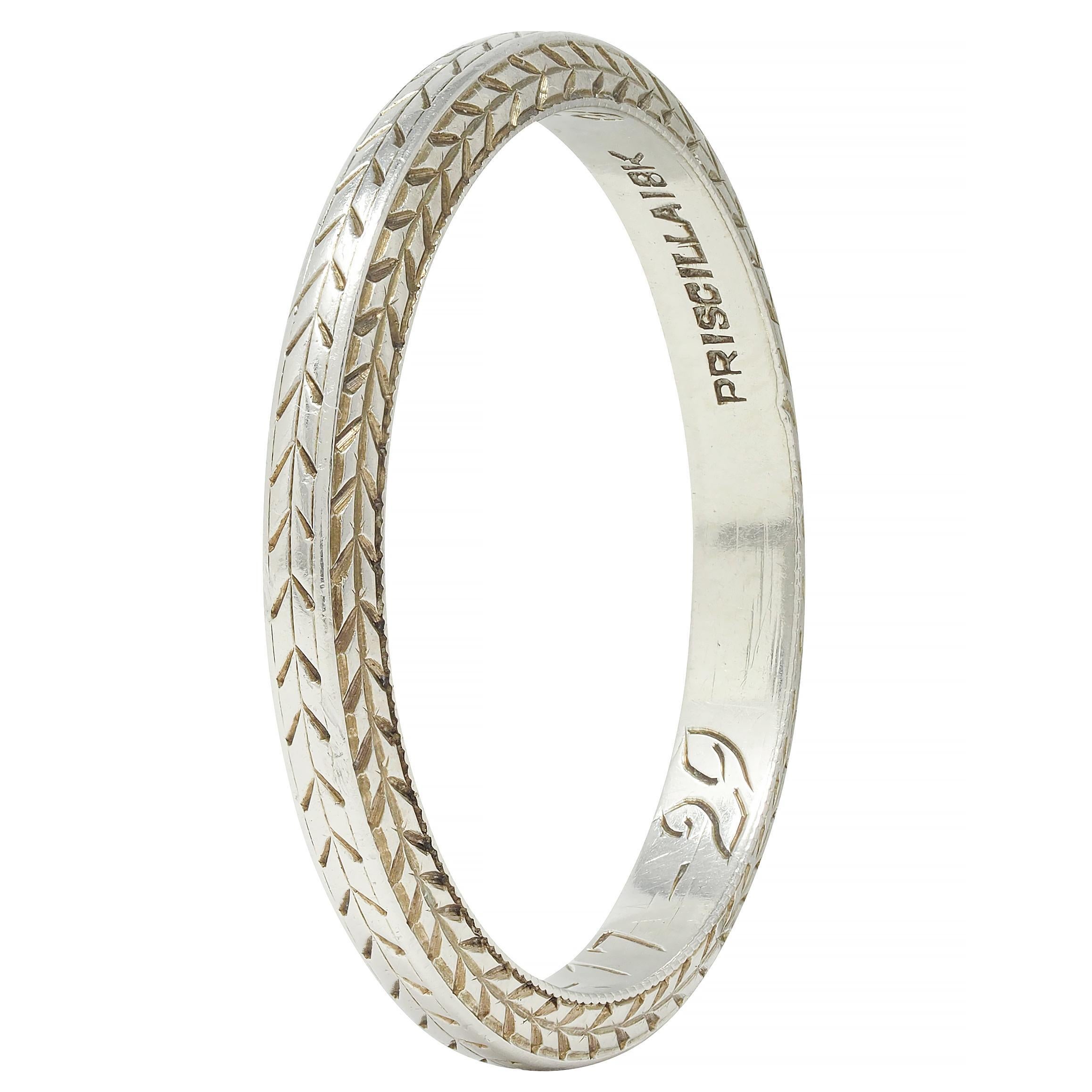 Band ring features engraved wheat motif fully around
Inscribed 'P.R.G to L.M.D 2-17-29.'
Stamped for platinum
With maker's mark for Eisenstadt Mfg. Co. Inc.
Circa: 1929; via dated inscription
Ring size: 5 3/4 and not sizable
Measures North to South