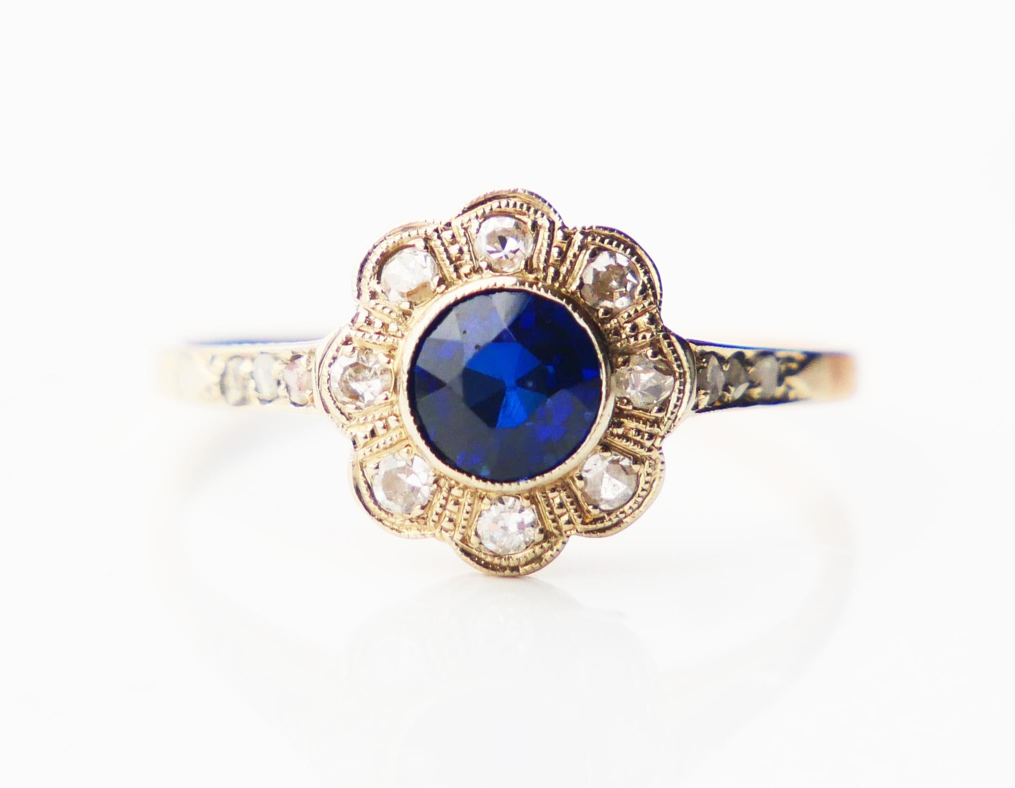 Beautiful 95-year-old Halo Ring in solid 18K Yellow Gold with lab-made Blue Sapphire and 14 natural Diamonds set in tight White Gold /Platinum clusters. Used finest condition.

Hallmarked 18K, Swedish customs and importer's hallmarks, year