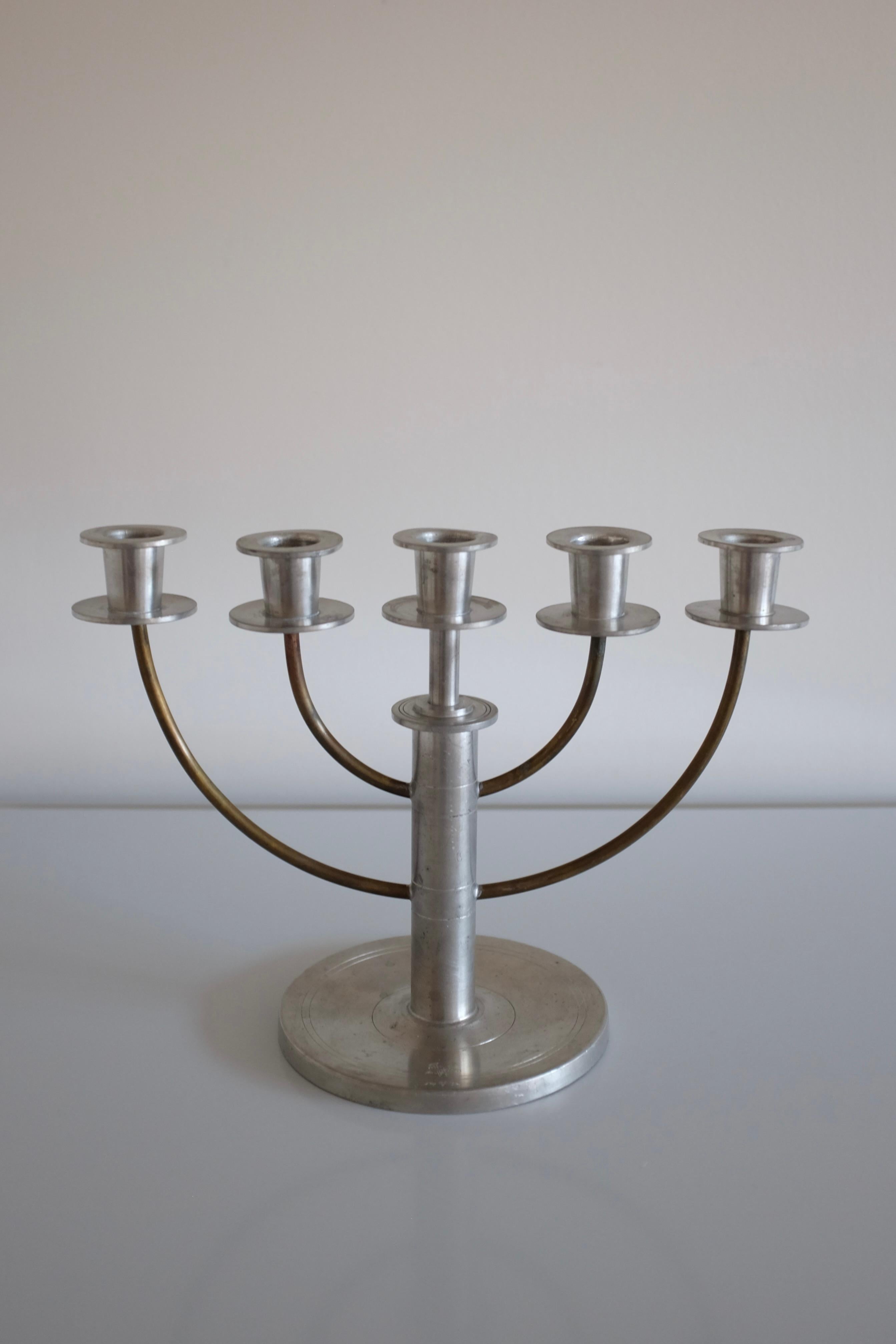 Beautiful 1929 Pewter and Brass candelabras attributed to Sylvia Stave for CG Hallberg, Sweden. Age appropriate wear with small engravings at the foot.

Dimensions: H 8 in. x W 11 in. x D 5 in.