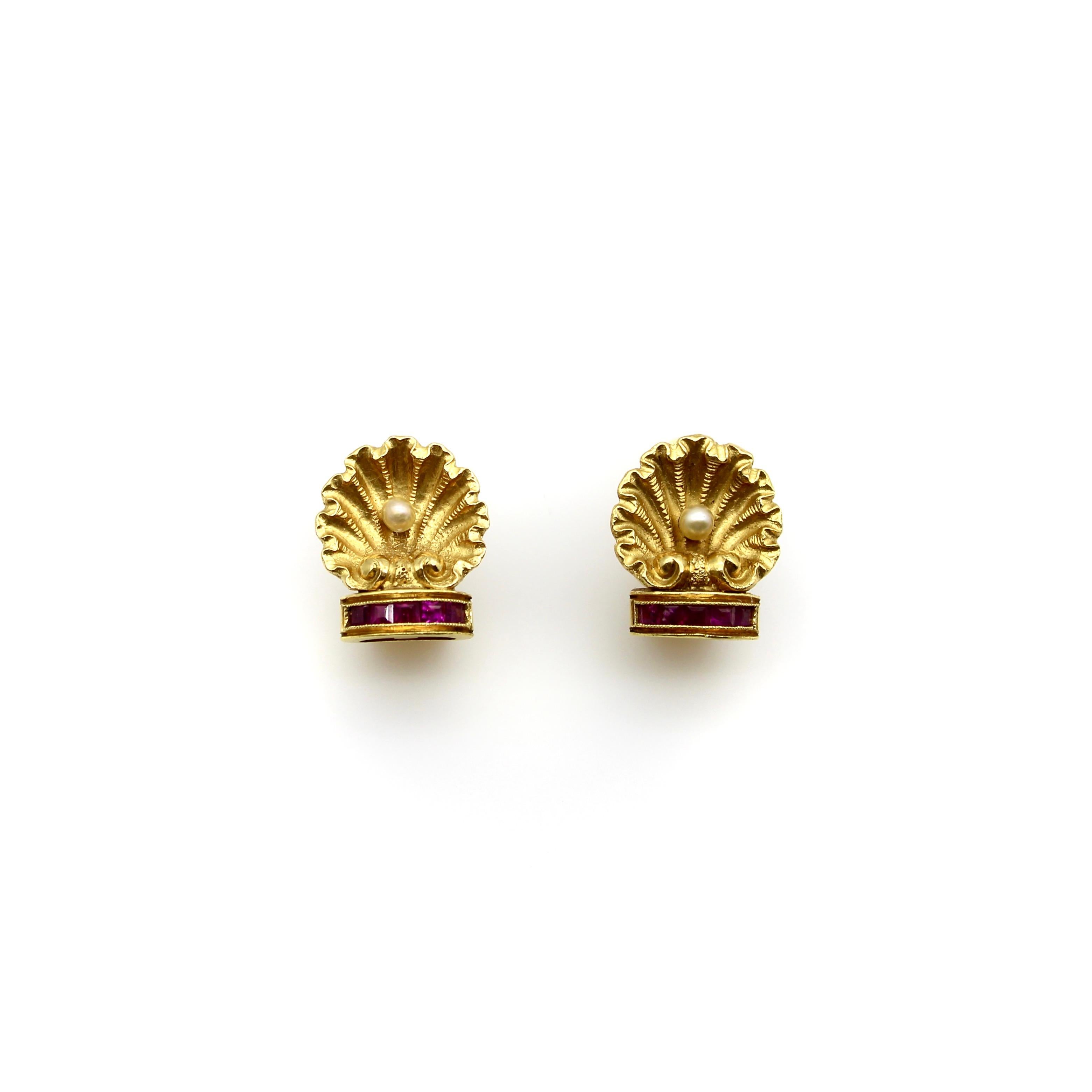 These 19.2k gold earrings are small, but have stunning theatricality to them—like tiny versions of an ornate architectural detail. Each earring is a beautifully rendered shell, opened to reveal a pearl at the bottom. The shell sits on a half-dome of