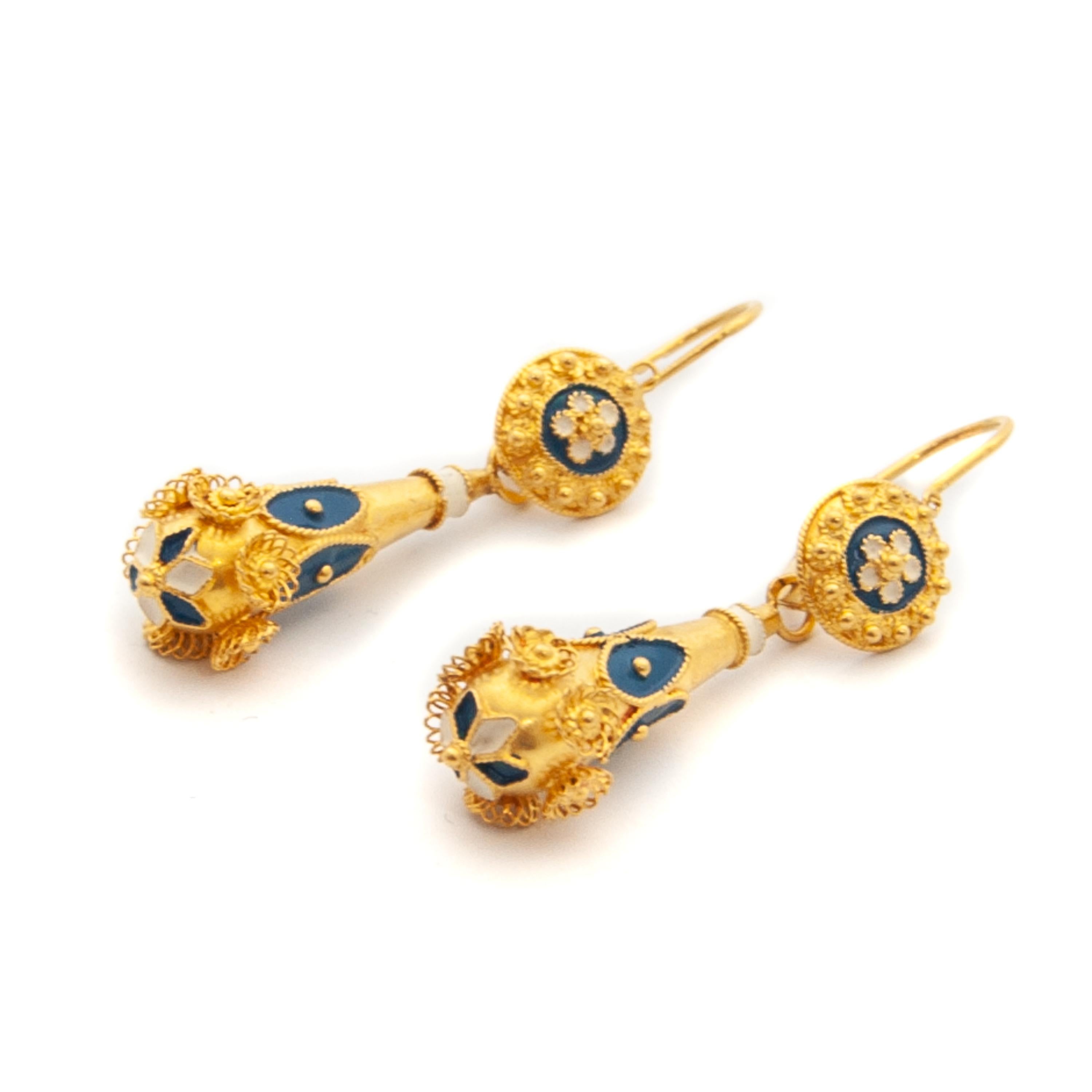 19.2K yellow gold blue and white enameled Portuguese dangle earrings. The earrings are beautifully detailed with enamel and filigree. The upper part of the earrings is represented by a flower enameled rosette surrounded by filigree knots. Hanging