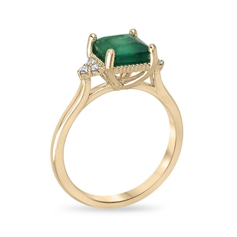 Elegance takes center stage in our Emerald and Diamond Cluster Engagement Ring, starring a 7x7mm almost perfectly square Asscher-cut emerald. Its lush green color, semi-transparent clarity, and pleasing yellowish-green hue are beautifully enhanced