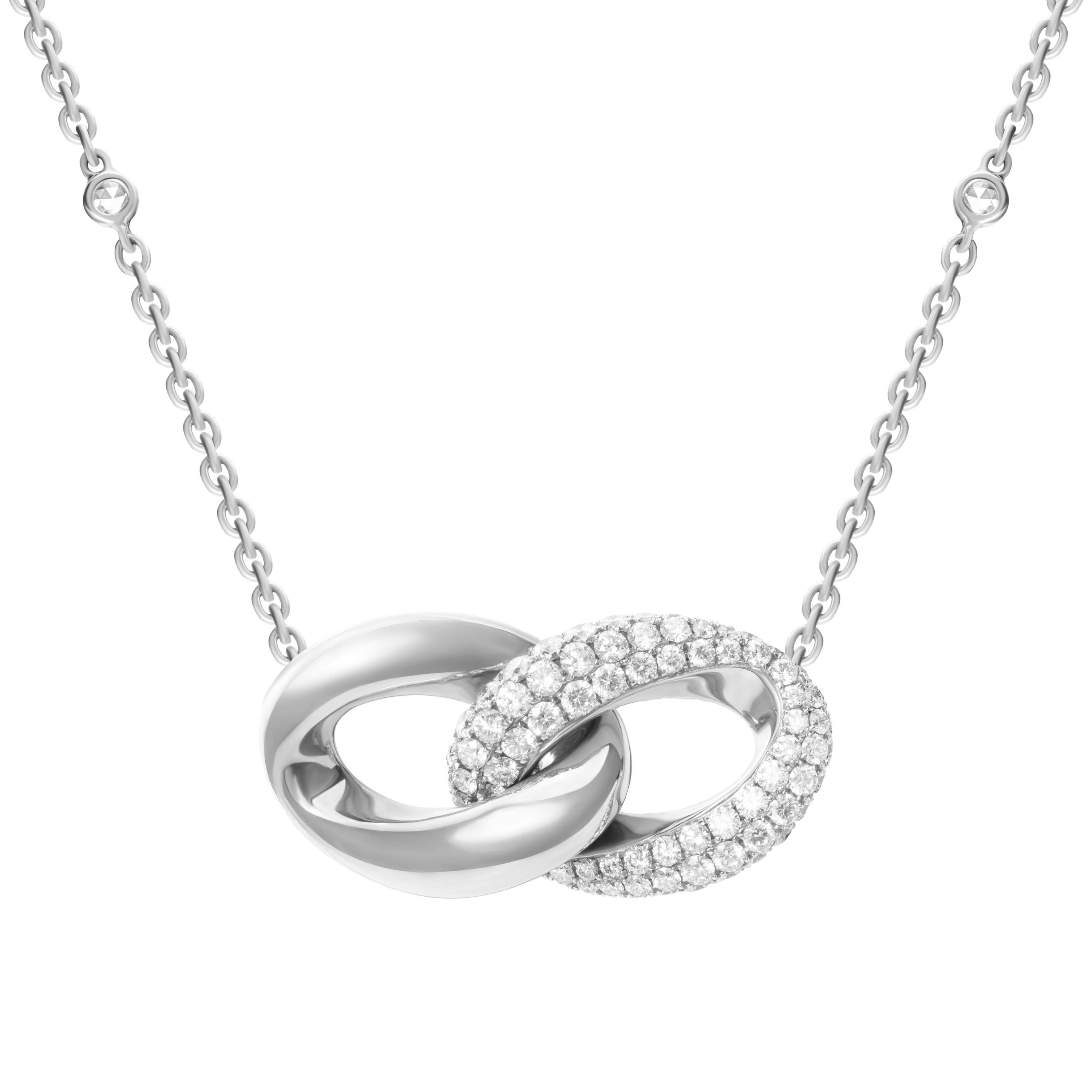 Defined by sleek curves and contours, this delicate necklace features a duo of interlocking loops in 18-karat white gold and 1.61 carats of pavé-set diamonds.  The cable chain features 0.32 carats of rose cut round diamonds.  Chain length 18 inches.