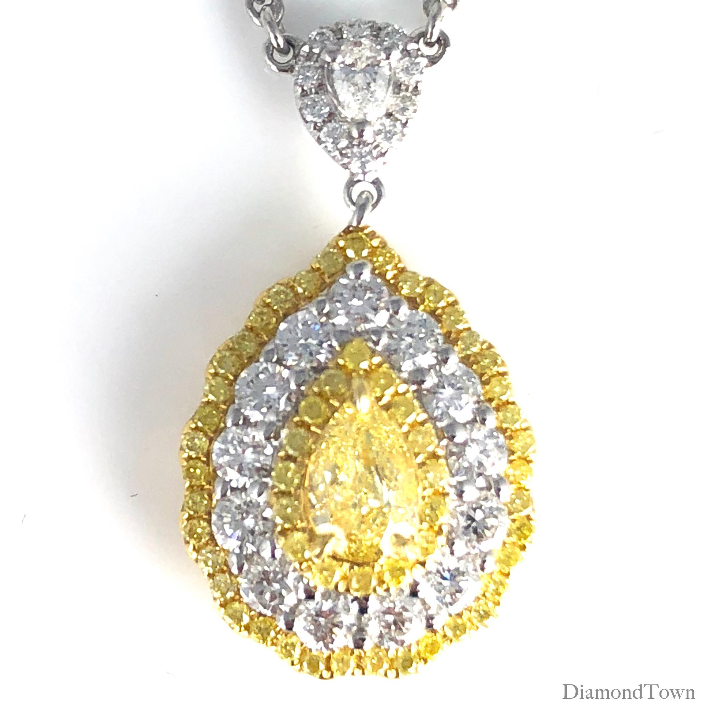 (DiamondTown) This stunning pendant features a GIA Certified 0.54 carat Pear Shape Yellow Diamond center, surrounded by a triple halo of round yellow and round white diamonds. Additional diamonds decorating the bail and along the chain bring the