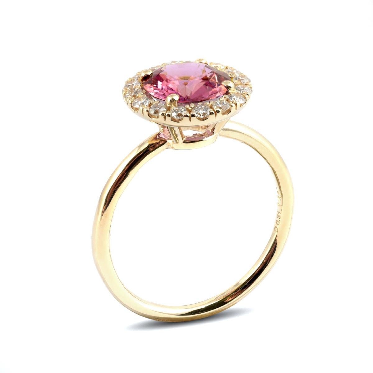 This simple yet pure design features a 1.93 carat, even toned Pink Sapphire set at the center of this delicate ring. Soulful, feminine and full of radiant color, here is a pink beauty that will easily have you falling in love. Surrounded by a well