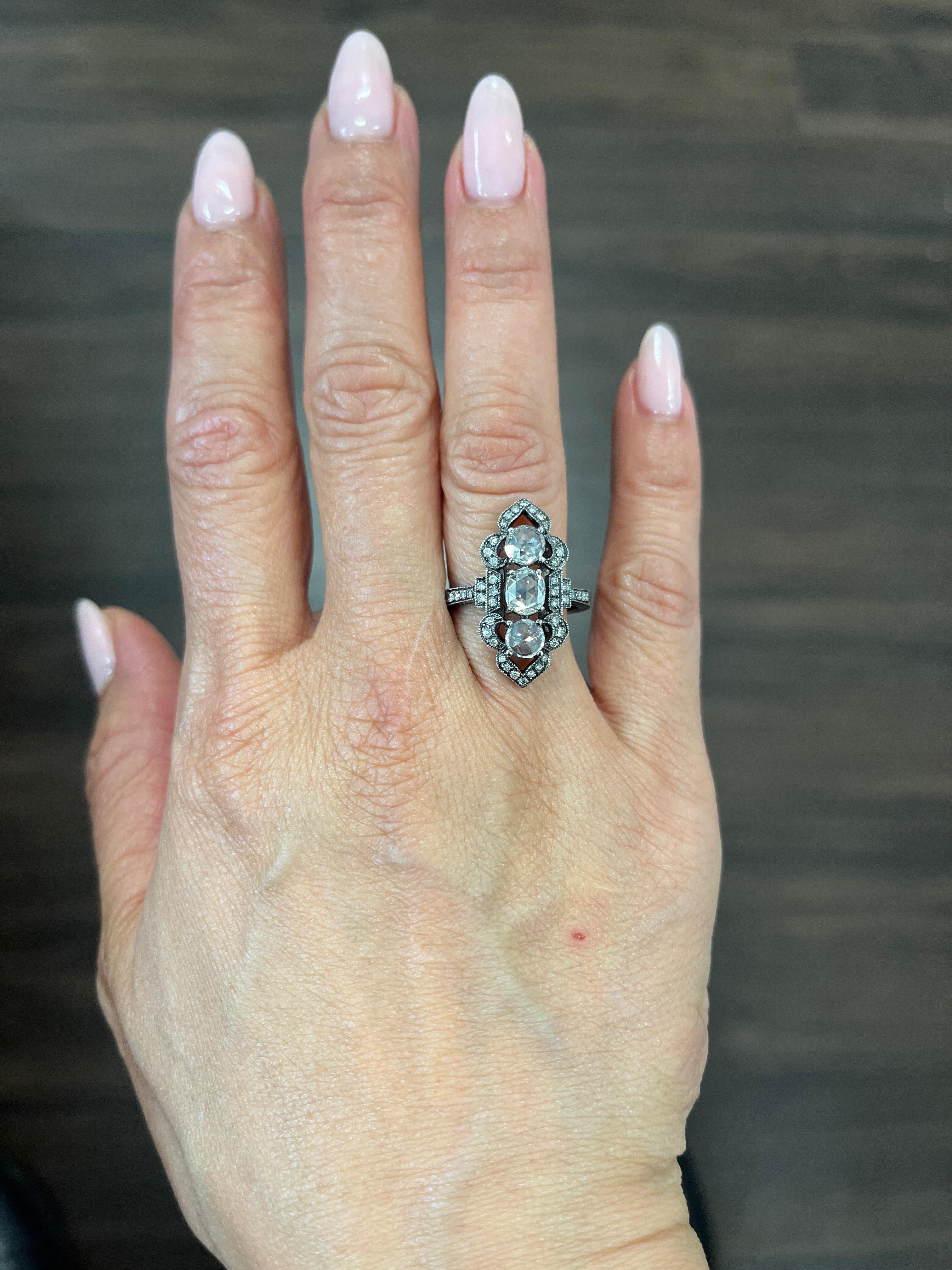 This exquisite ring boasts a stunning 1.93 carat total weight with rose cut diamonds set in 18k white gold. The diamond's clarity grade falls in the VS2/SI1 range and has a beautiful H/I color grade. The ring is also accented with 47 additional