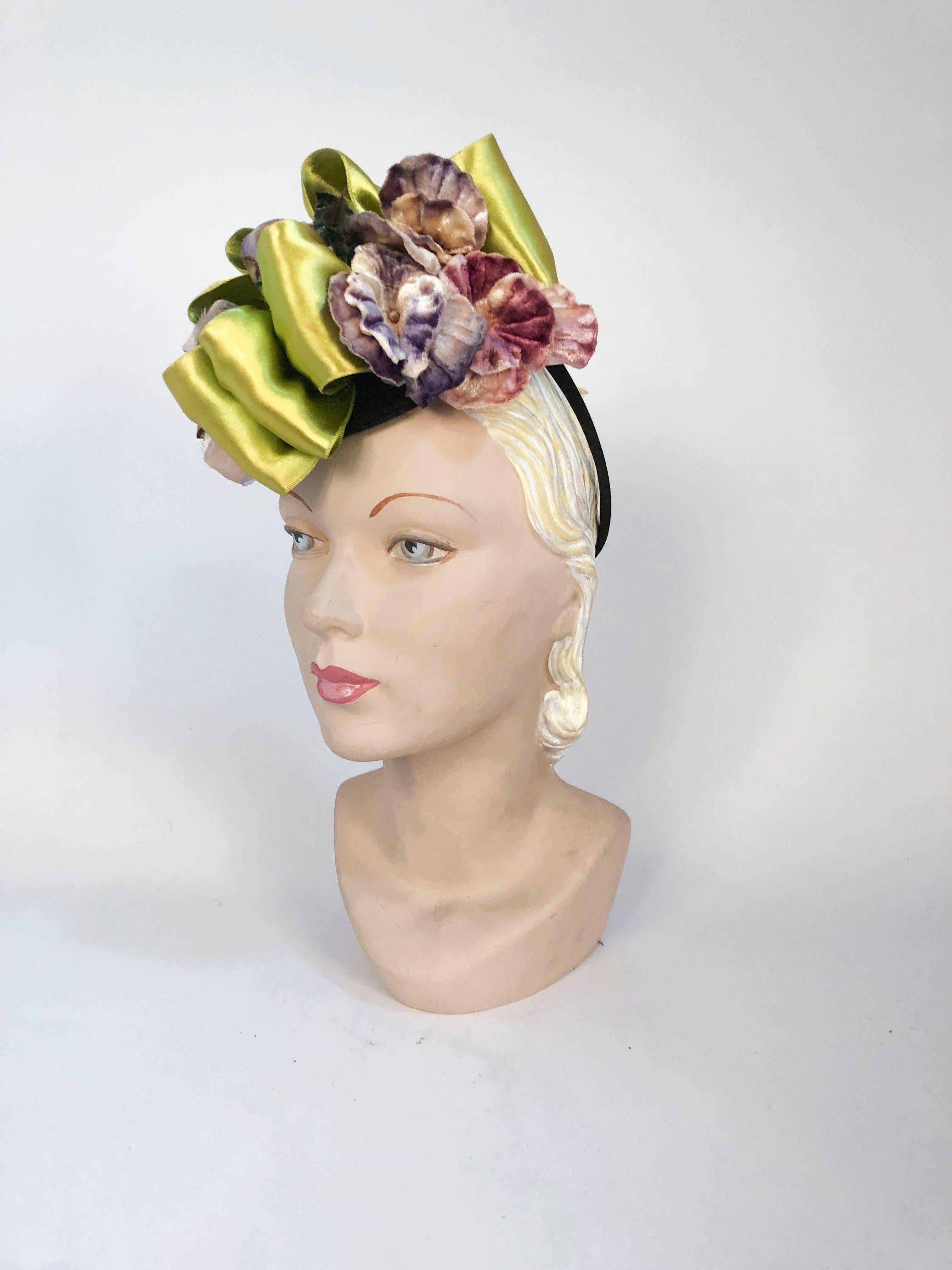 1930/1940s Chartreuse/Green Satin and Violet Velvet Flower Cocktail Hat. The flowers have shades of purple, violet, and mauve. The Satin ribbon is vibrant chartreuse and is hand-looped throughout the set silk velvet flowers and ends with two ribbon