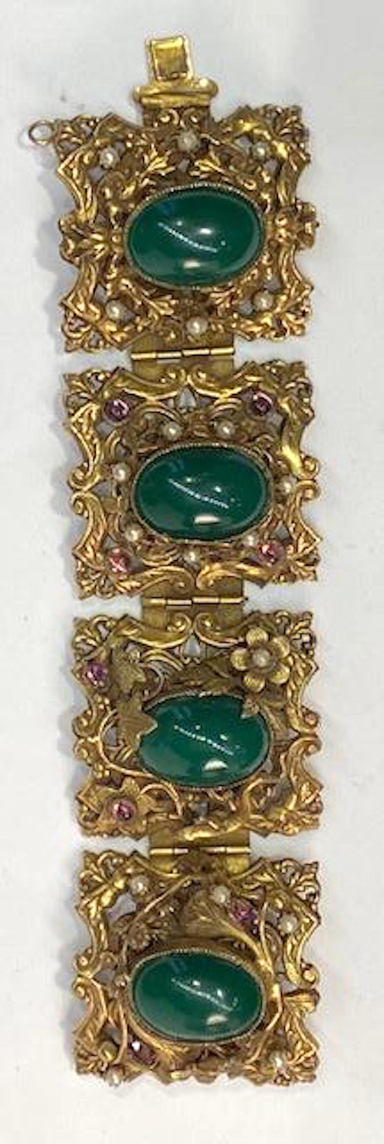 A stunning and large 1930s to 1940s ornate four panel link bracelet with antique gold patina. Most likely from Czechoslovakia. Each panel is individually made and different. Photo 10, with push pin of clasp, through photo 13 are in order. Starting