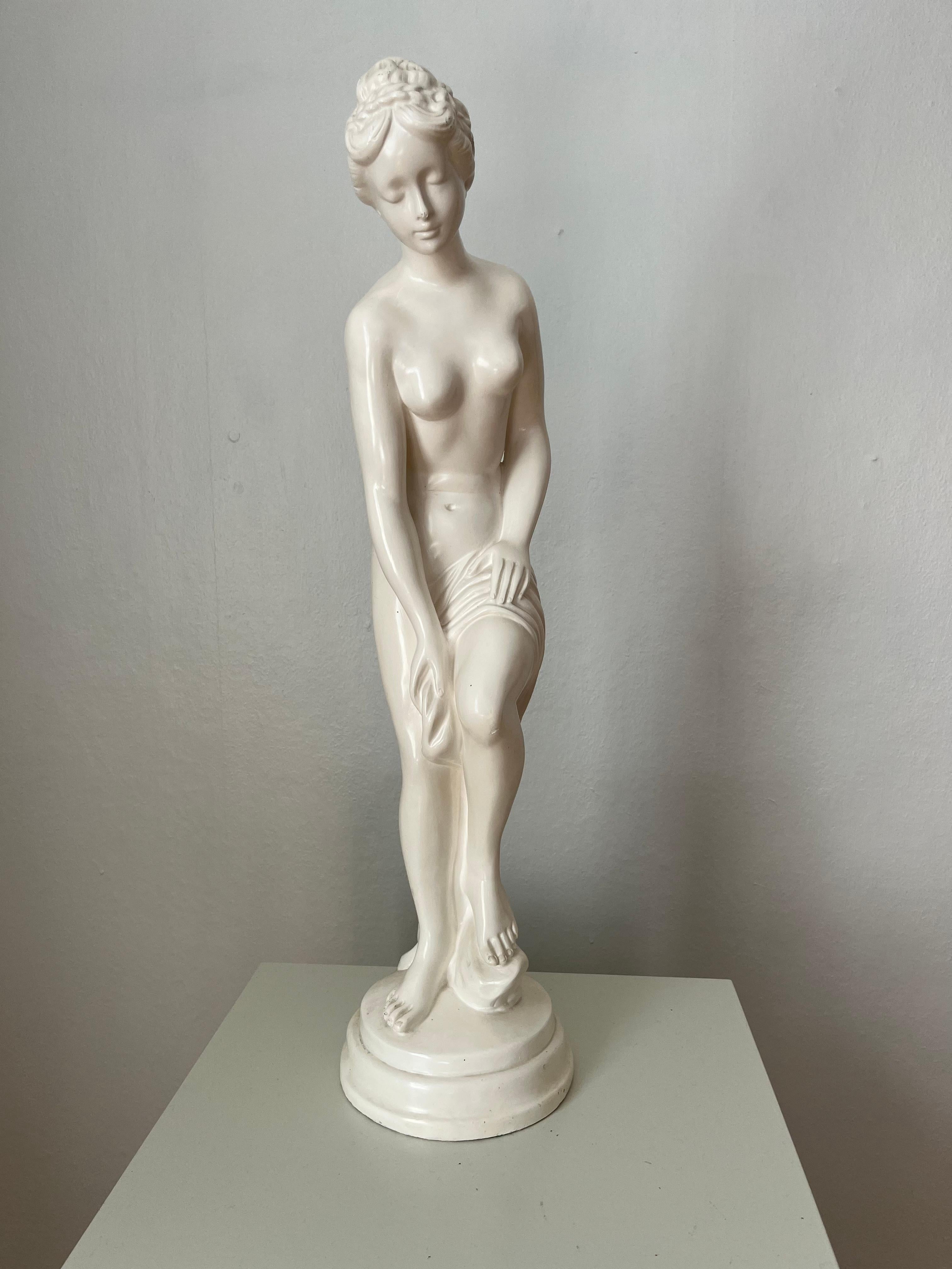 This Swedish decorative figurine in the shape of a standing woman is made of white plaster and made in the first half of the 20th century. 

Good vintage condition, few signs of age and wear and one small chip/loss in the glaze on the back, that has