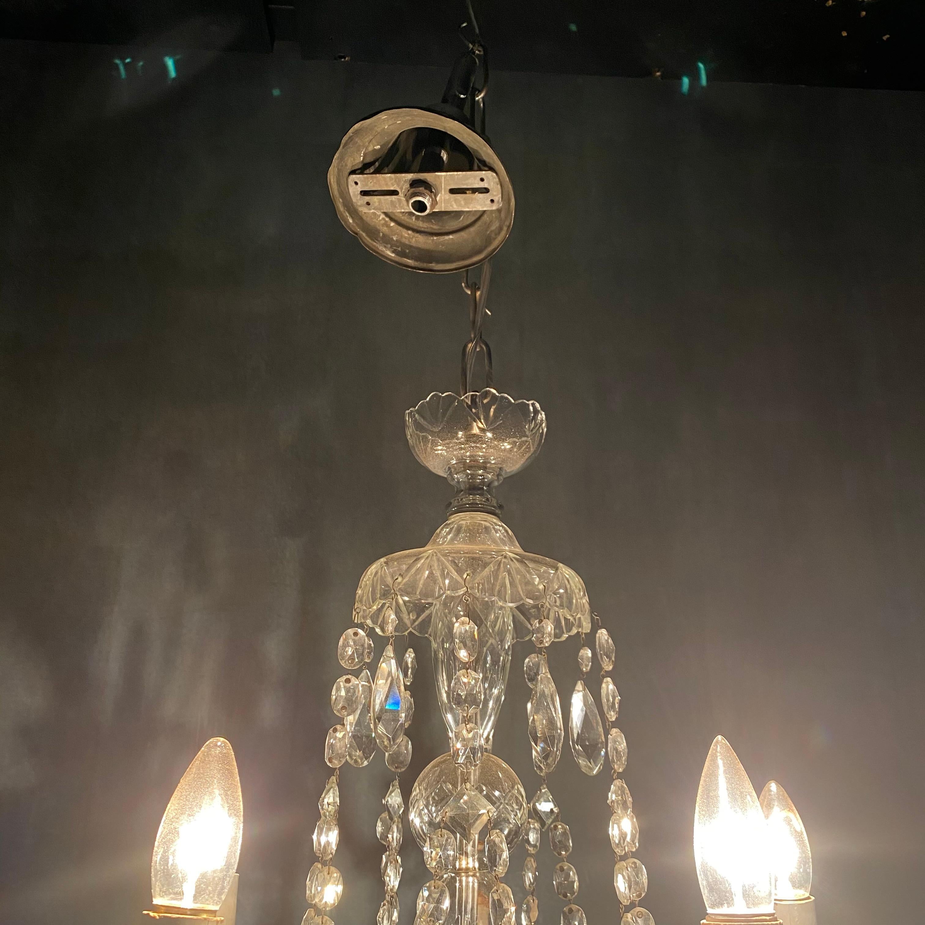 A nice simple chandelier with impressive 5 arm configuration and swooping glass crystal details .
 This piece was acquired from a private collection in Toronto nix purchased in Chicago, in the 70's;

Rewired tested and functional.
