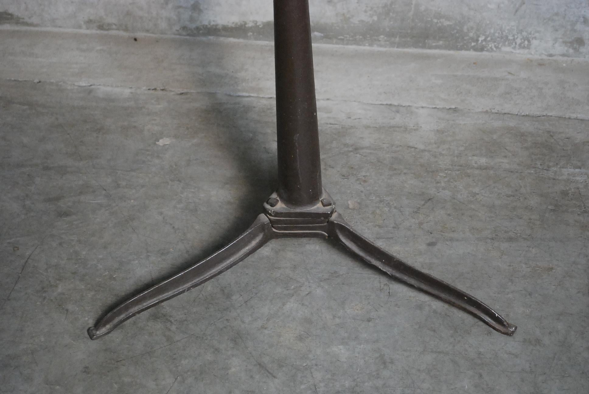 Cast iron base on this oak top table with height and angle adjustments, ideal for stand up work or hostess stand ..many options.

Found n Chicago.
