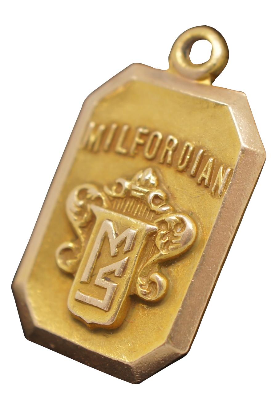 Antique Panikoff 10k yellow gold charm with the word “Milfordian” and the coat of arms of the Milford School. Engraved on the back “J.F. Gagel 1930.”

0.5” x 0.875” / 3.8 g (Width x Depth)