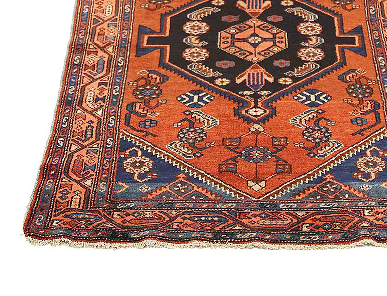 Antique Persian runner rug handwoven from the finest sheep’s wool and colored with all-natural vegetable dyes that are safe for humans and pets. It’s a traditional Malayer design featuring three large geometric and floral medallions over an orange