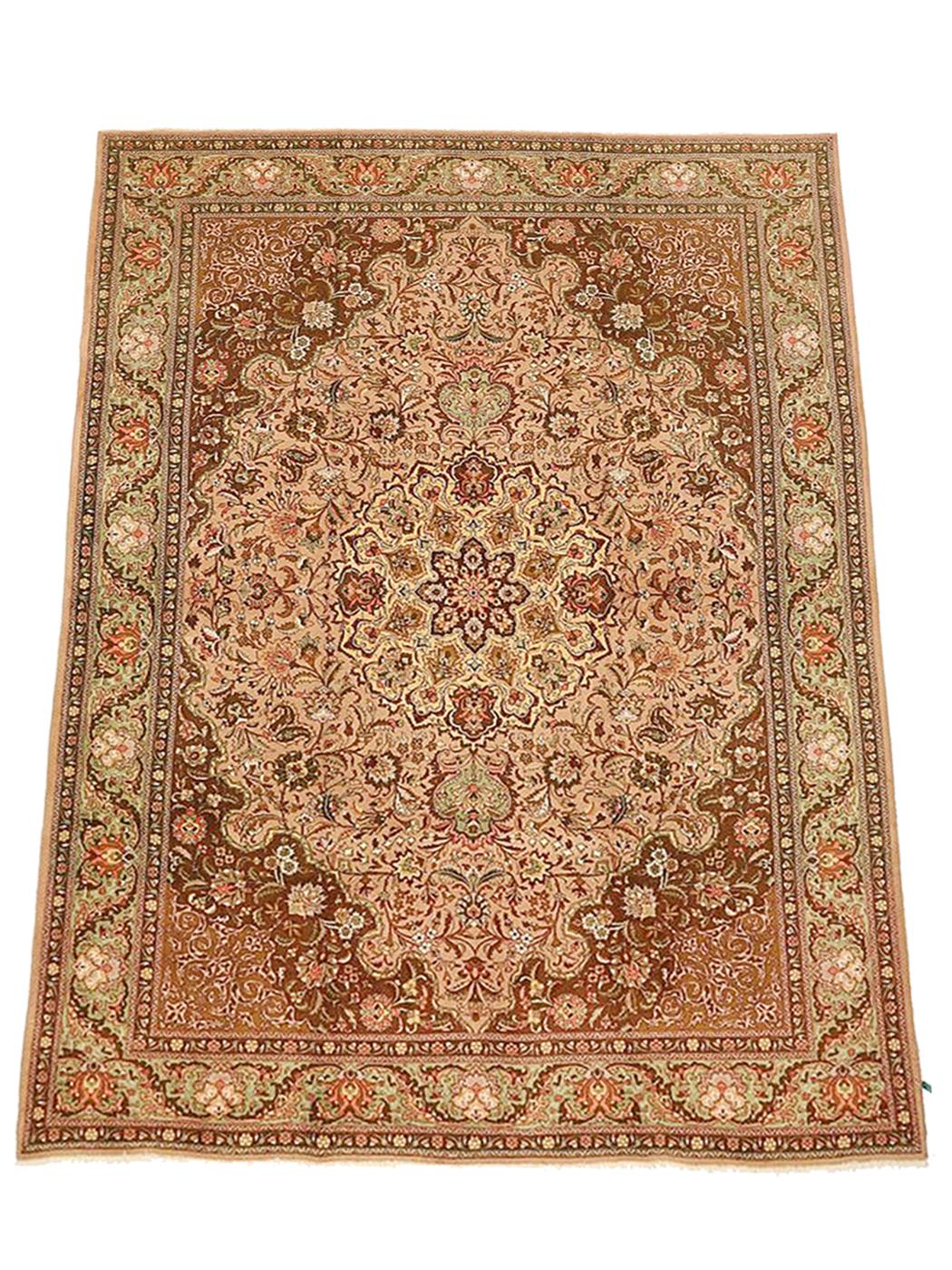 Vintage Persian rug handwoven from the finest sheep’s wool and colored with all-natural vegetable dyes that are safe for humans and pets. It’s a traditional Tabriz weaving featuring a lovely ensemble of floral designs in brown and pink over an ivory