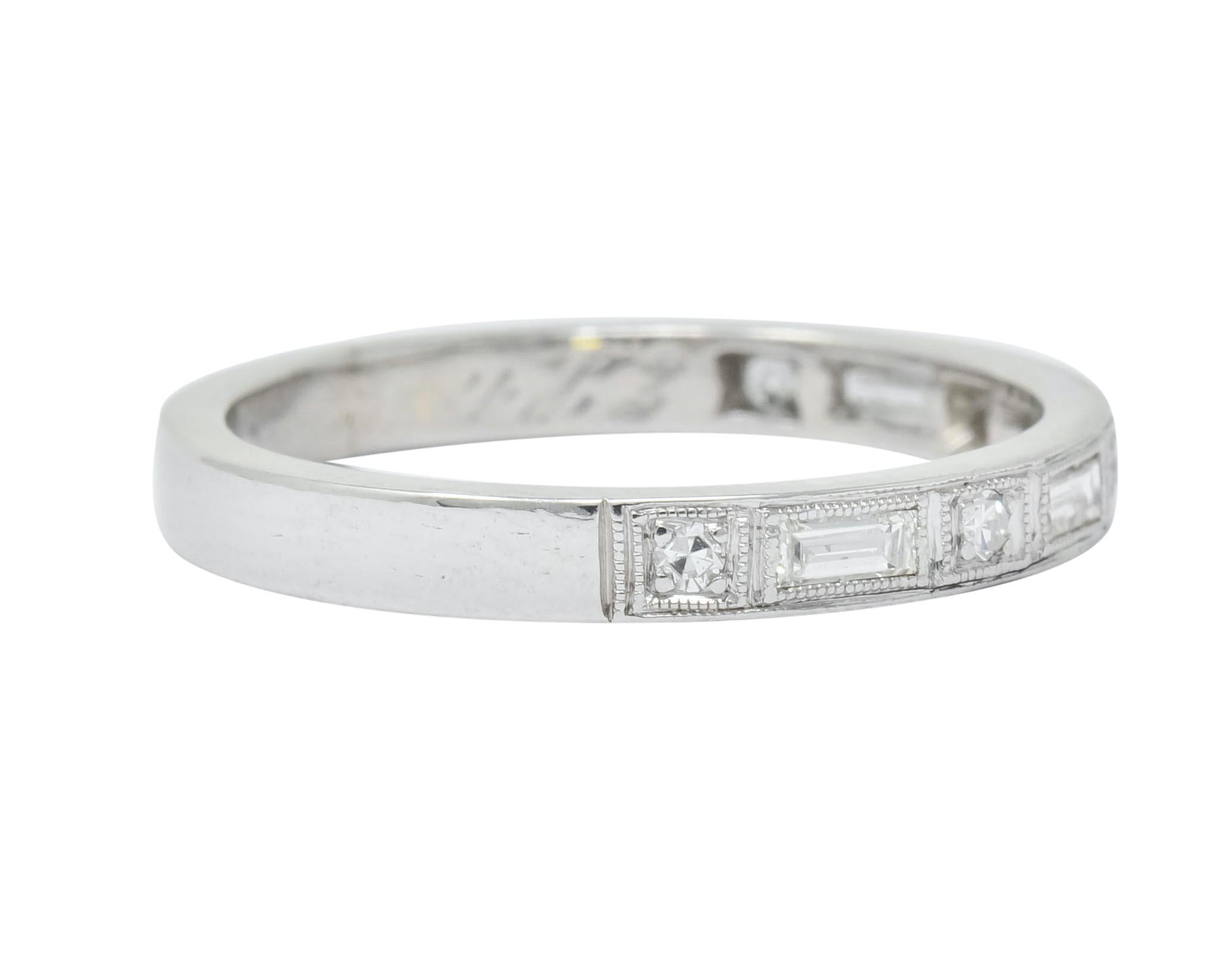 Band style ring with baguette cut and single cut diamonds weighing approximately 0.40 carat, F/G color and VS clarity

Set to front and alternating within millegrain framing

With dated inscription

Stamped Irid Plat for platinum-iridium

Ring Size: