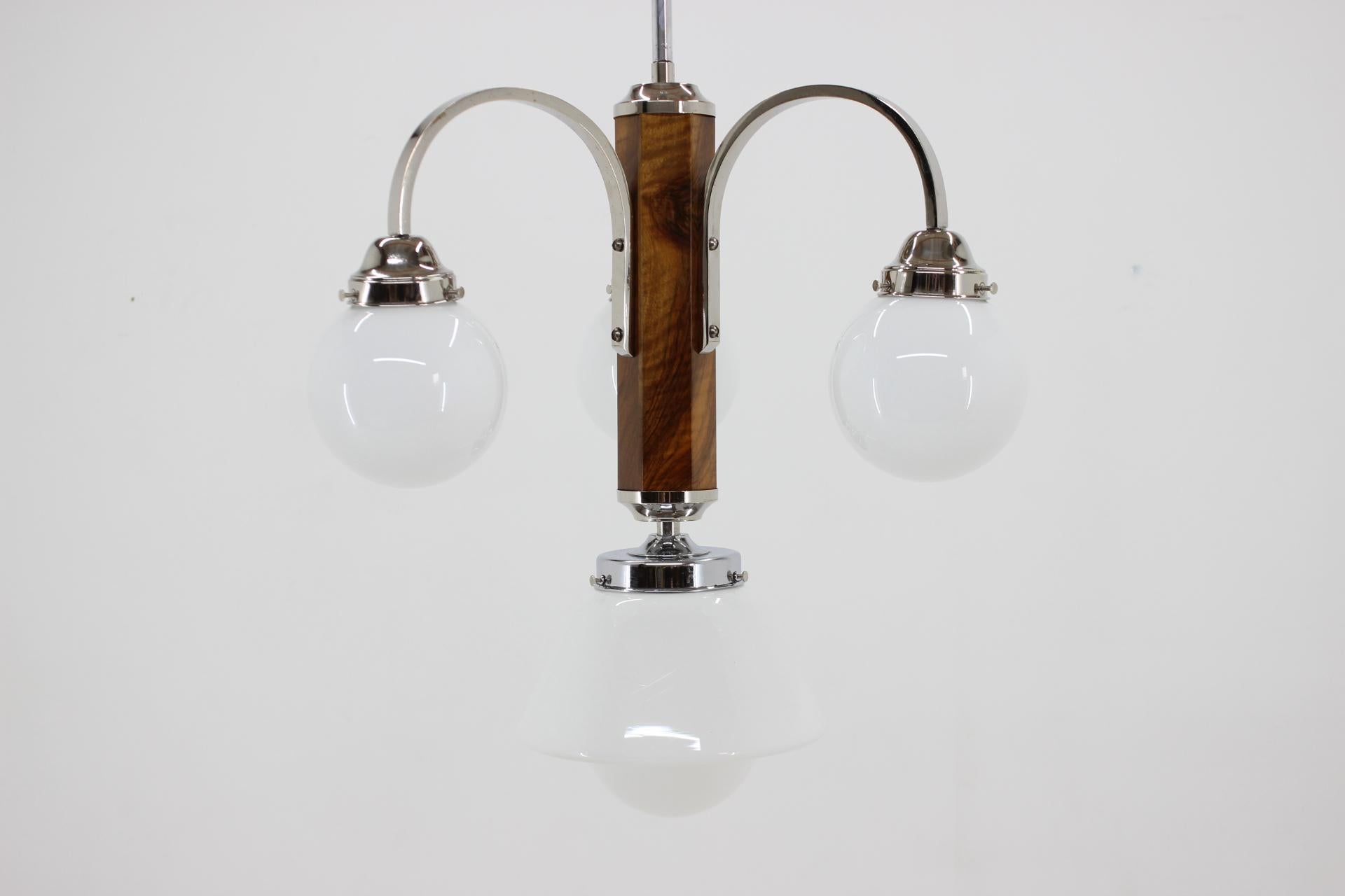 Completely restored Art Deco chandelier. 
Walnut with new shellac finish. 
Chrome with minor patina polished. 
Rewired: two separate circuits - 3+1x40W, E25-E27 bulbs. 
US wiring compatible.