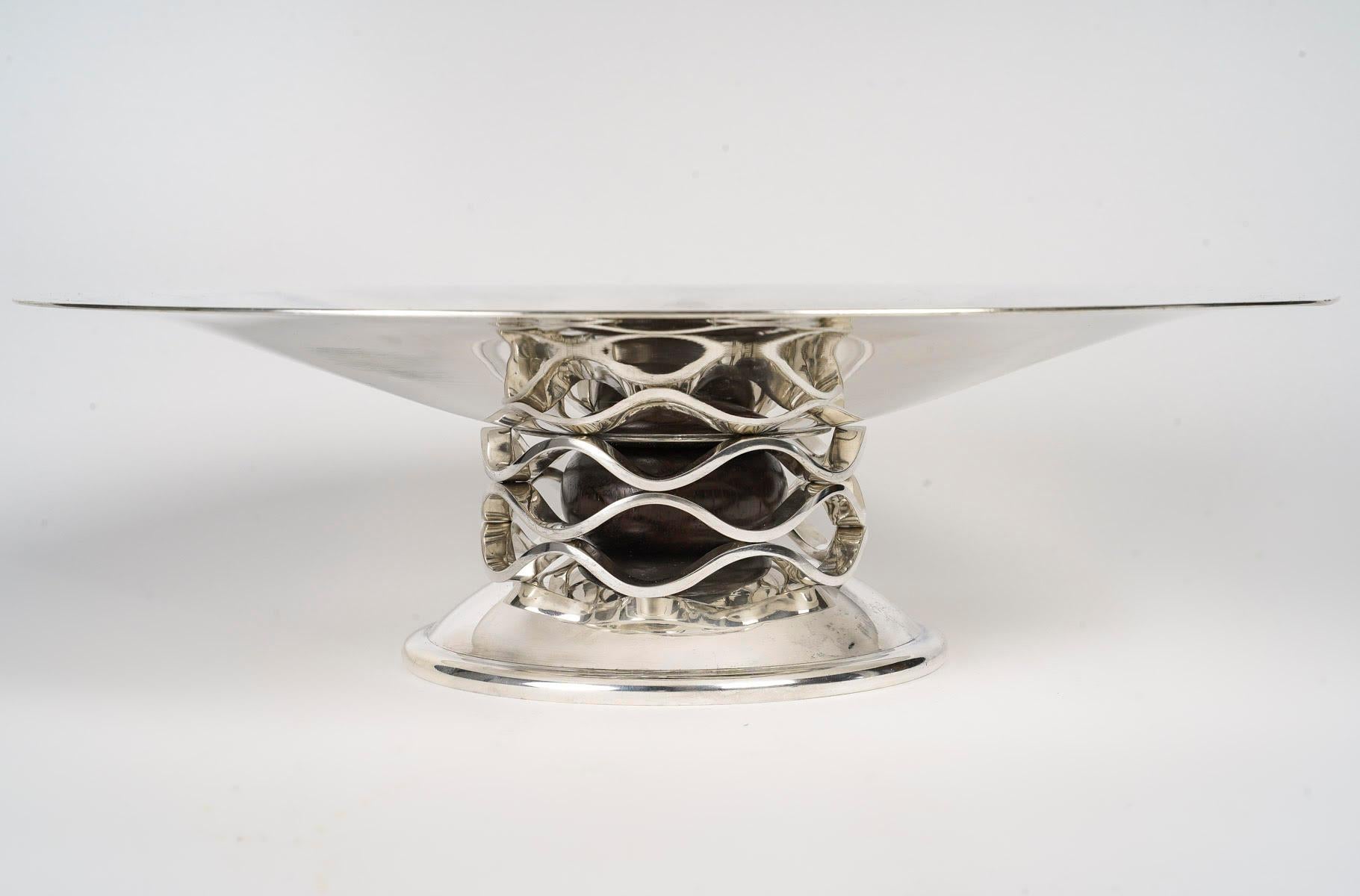 1930 Art Deco silver plated fruit bowl by Christofle.

Silver-plated metal and solid wood bowl signed by the House of Christofle, circa 1930, Art Deco period.  
d: 35cm, h: 10cm