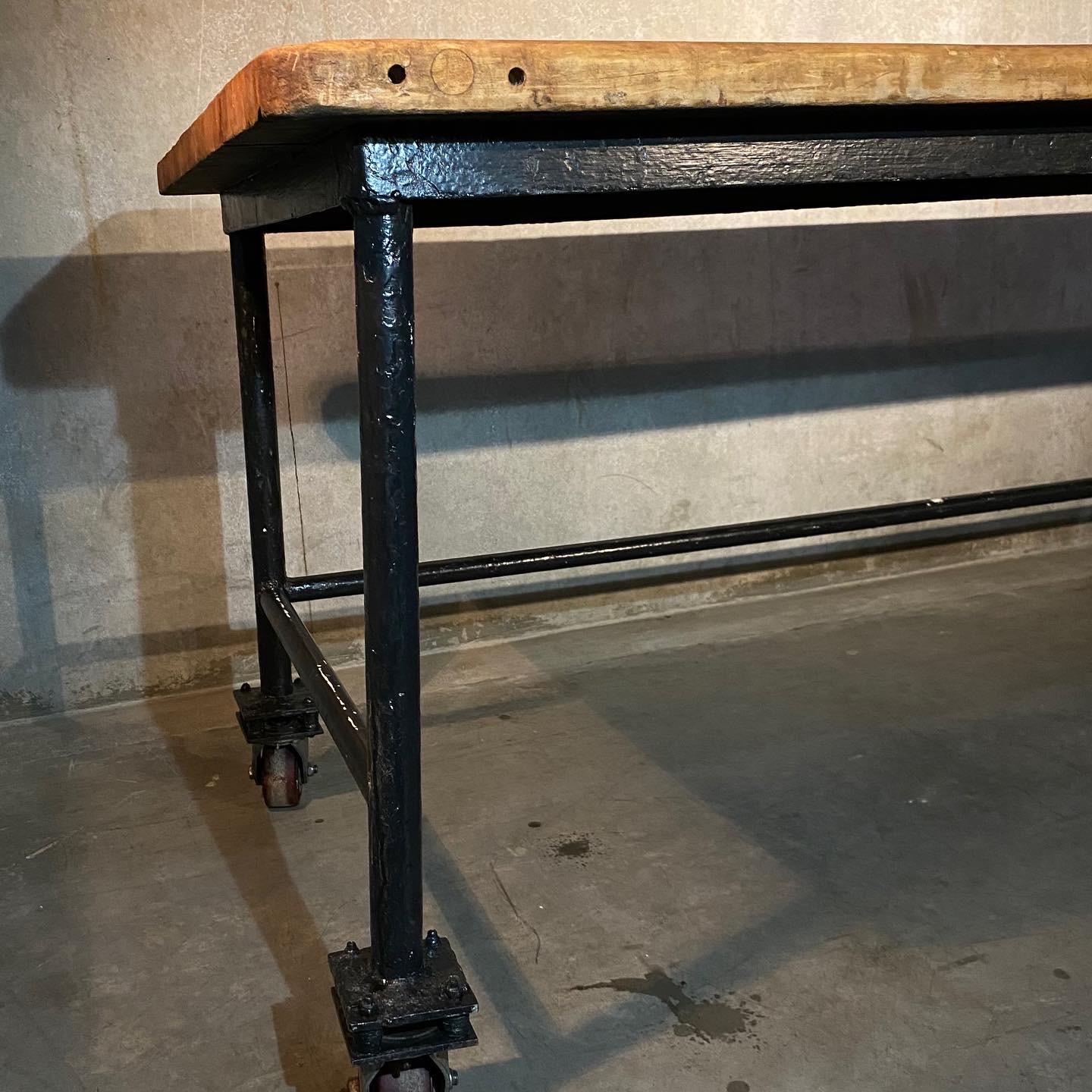 A very nice original table salvaged from a defunct bakery in BC.  This piece shows rolling casters,  solid top , old finish and support bar with open section for stools etc...

As found  from a local collection.