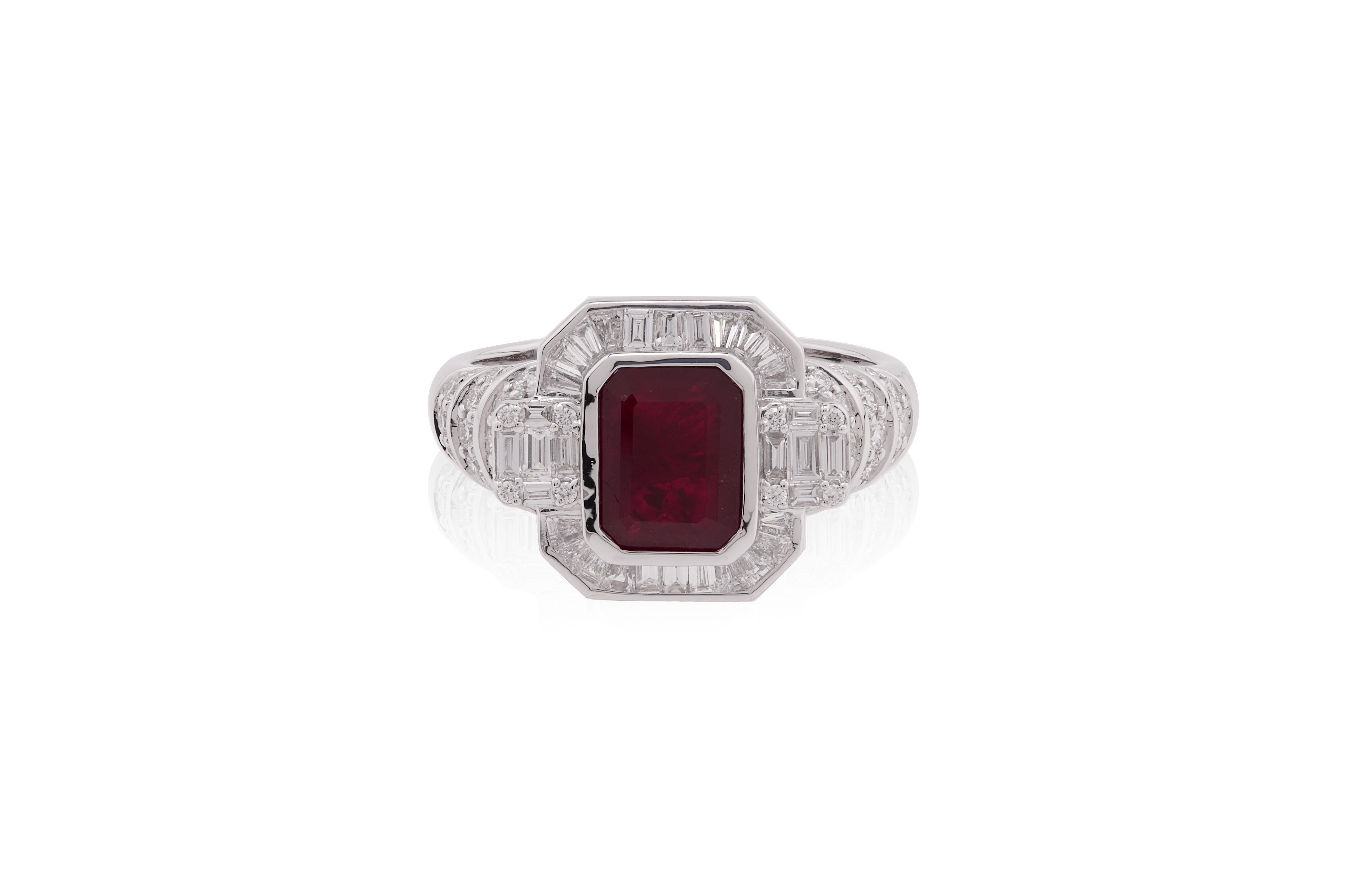 This exquisite ring features a striking, emerald-cut deep red ruby as its centerpiece, exuding elegance and timeless allure. The ruby is securely set in a sleek, high-polish white gold—enhancing the richness of the gemstone's hue. Surrounding the