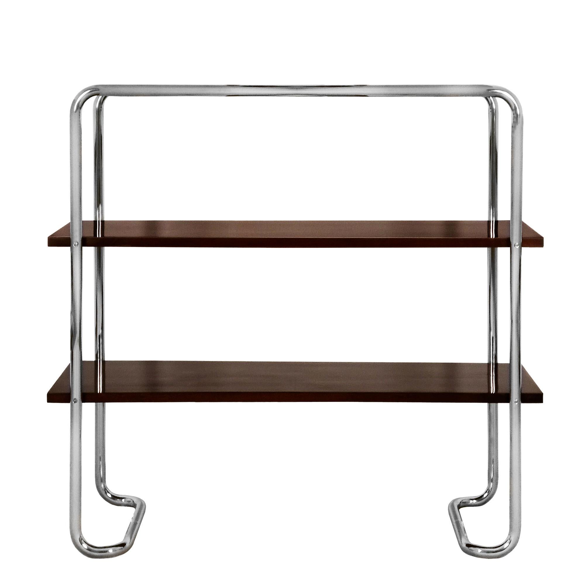 Console with a nickel plated steel tubular stands and three shelves in solid wood with walnut veneer, French polish. 

In the style of Bauhaus Movement.

Spain, Barcelona c. 1930.