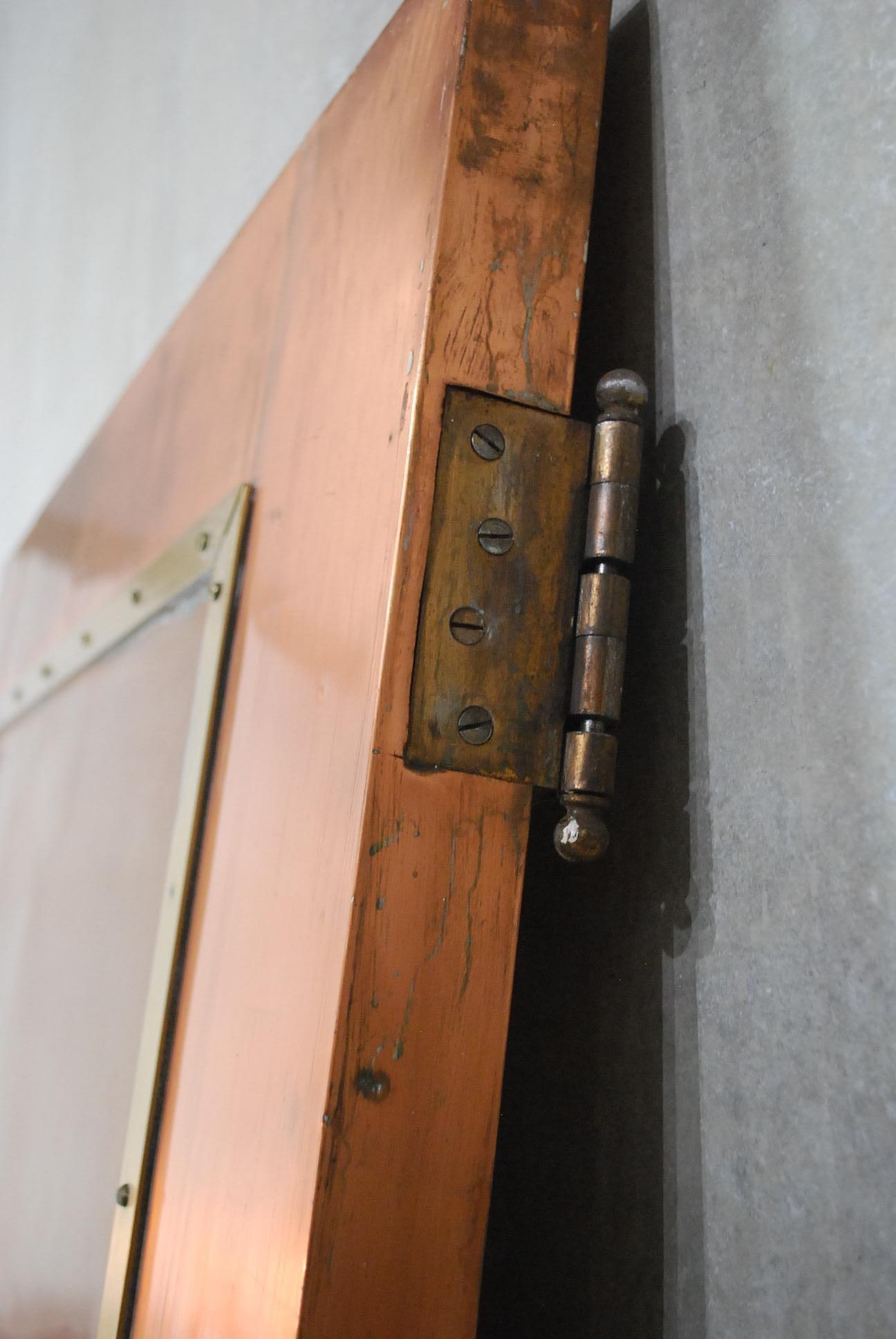 Beautiful copper cladded two-sided door with brass hi light panels.
Salvaged from an industrial building in Montreal. A rare find. hang on tracks or use existing hinges for swing door.