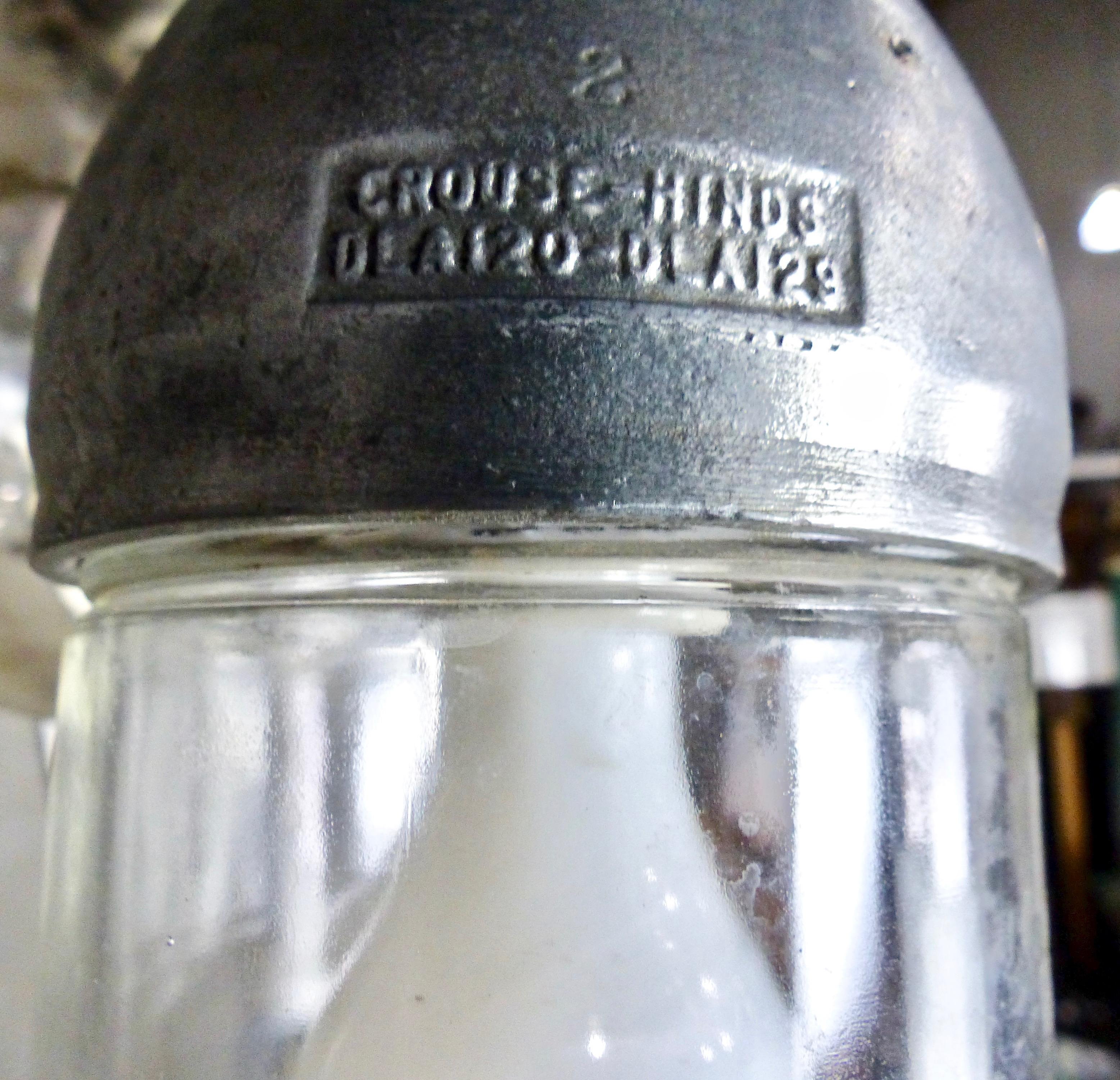 Authentic and instantly recognizable Crouse Hinds industrial/factory pendants, circa 1930. Nearly 100 years old, and still on trend. Signed cast metal housings with ‘teardrop’ shaped glass globes. Re-wired and approved to current electrical