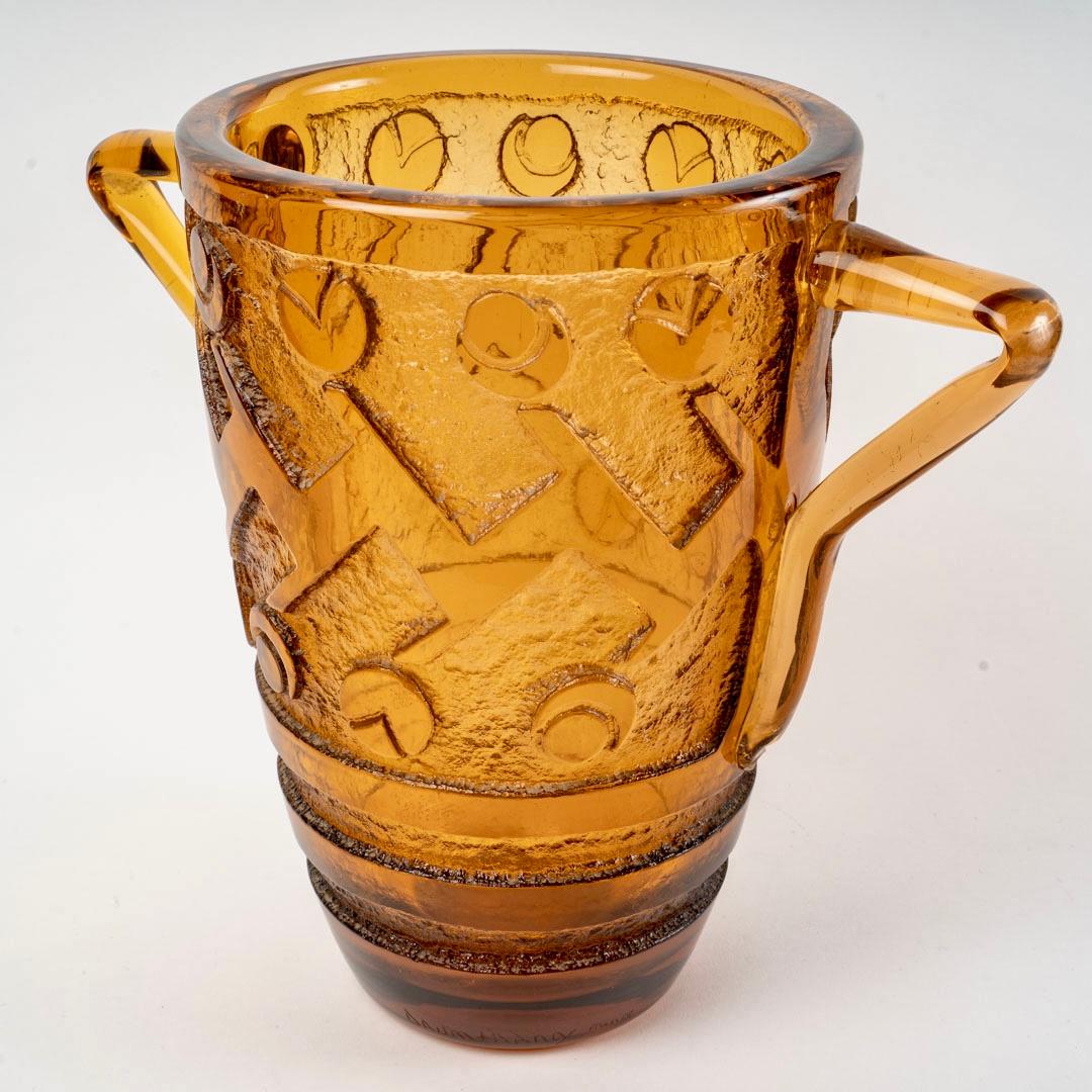 Vase Art-Deco with handles made in amber orange glass with acid-etched geometric design created by Daum in 1930s.
Engraved signature.

Perfect condition. Gorgeous tint. Very rare model.

height: 36 cm