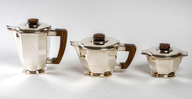 Tea and coffee service in pure sterling silver and maccasar made by Ernest Prost created in the 1930s.

Service including:
- a coffee maker
- a teapot
- a sugar bowl

Minerve Solid Silver 950/1000 French mark - maker's stamp and signature on