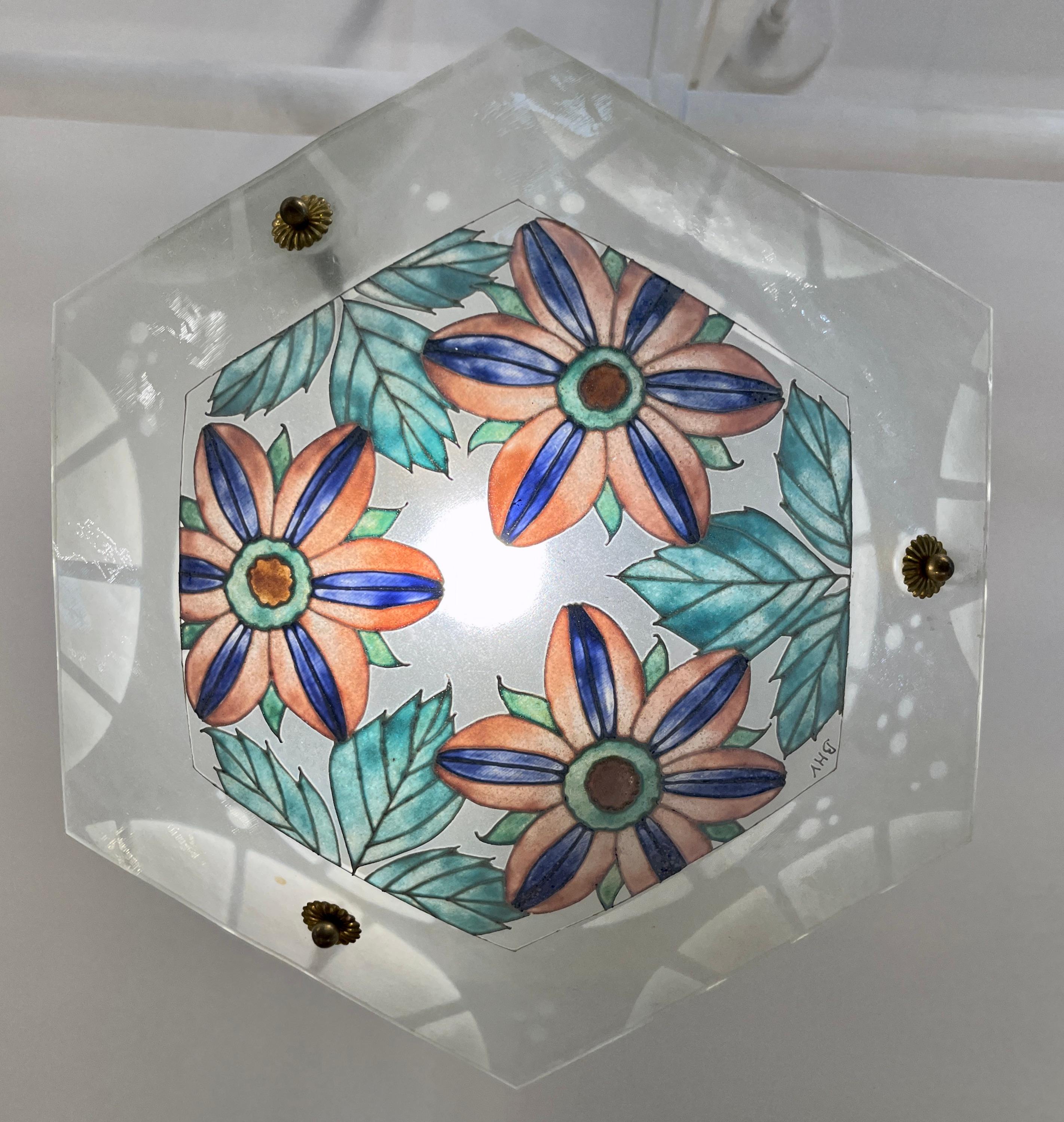 A charming early 20th-century decorative art hanging chandelier, in the manner of Loys Lucha, featuring a hand enameled floral motif on a frosted art glass plateau, with the outer edge decorated with a dotted geometric design, signed BHV. This