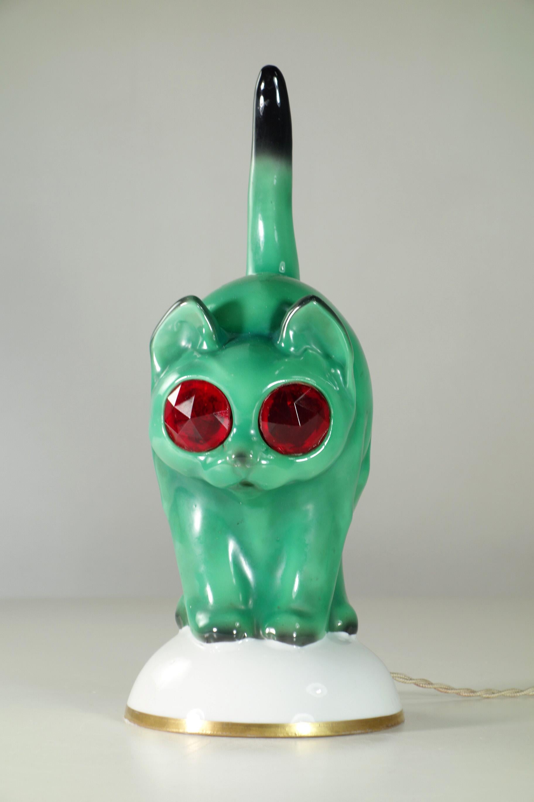 Cat Table Lamp
Goebel
Germany, 1930

Enamel Porcelain Cat with Red Glass Eyes
Original  electric system in perfect working order
Rare edition original Art Deco
Excellent condiction
No cracks