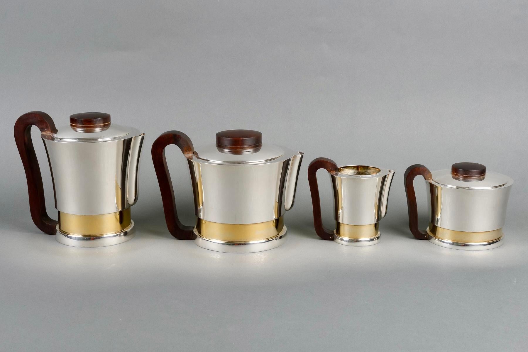 Art Deco Modernist tea and coffee set in sterling pure silver, vermeil and rosewood by Jean E. Puiforcat created in the 1930s.

Service including:
- a coffee pot 
- a teapot
- a milkpot
- a sugar pot

Minerve Solid Silver 950/1000 French mark -