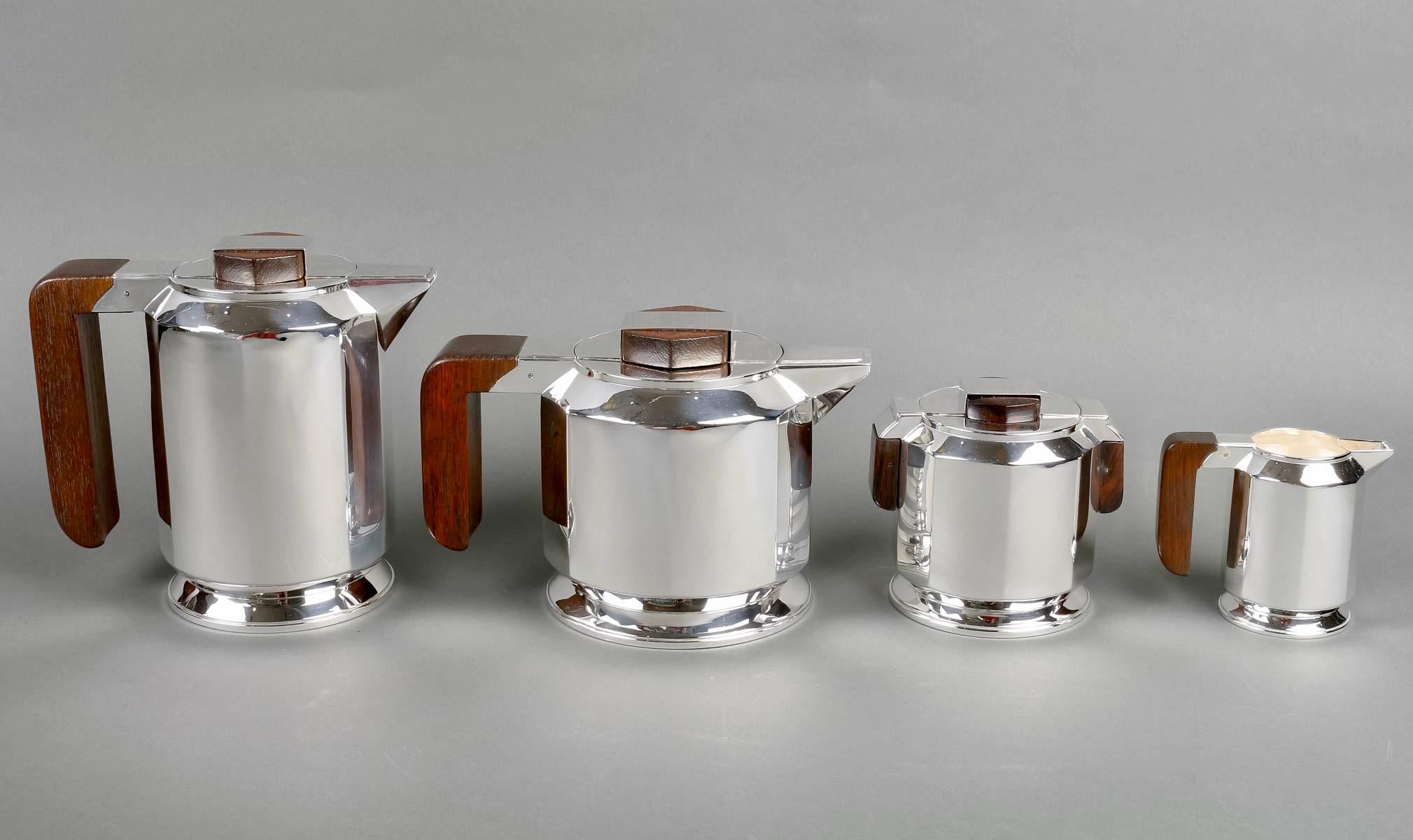 Modernist Art Deco tea and coffee egoiste set in sterling pure silver and rosewood by Jean E. Puiforcat created in 1925 for the shop Saks on 5th Avenue in NYC. 

Service including:
- a coffee pot 
- a teapot
- a milkpot
- a sugar pot

Minerve Solid