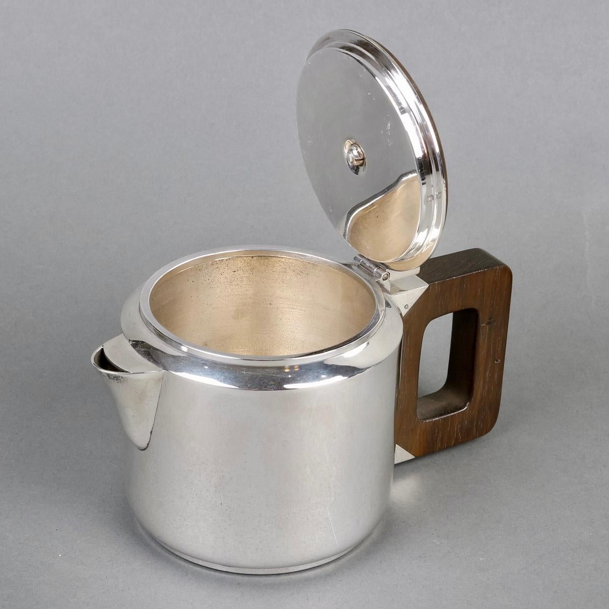 Art Deco Modernist tea and coffee egoiste set in sterling pure silver and rosewood by Jean E. Puiforcat created in the 1930s.

Service including:
- a coffee pot : 9 cm x 9 cm
- a teapot : 8 cm x 10 cm
- a milkpot : 5.5 cm x 5.5 cm
- a sugar pot :