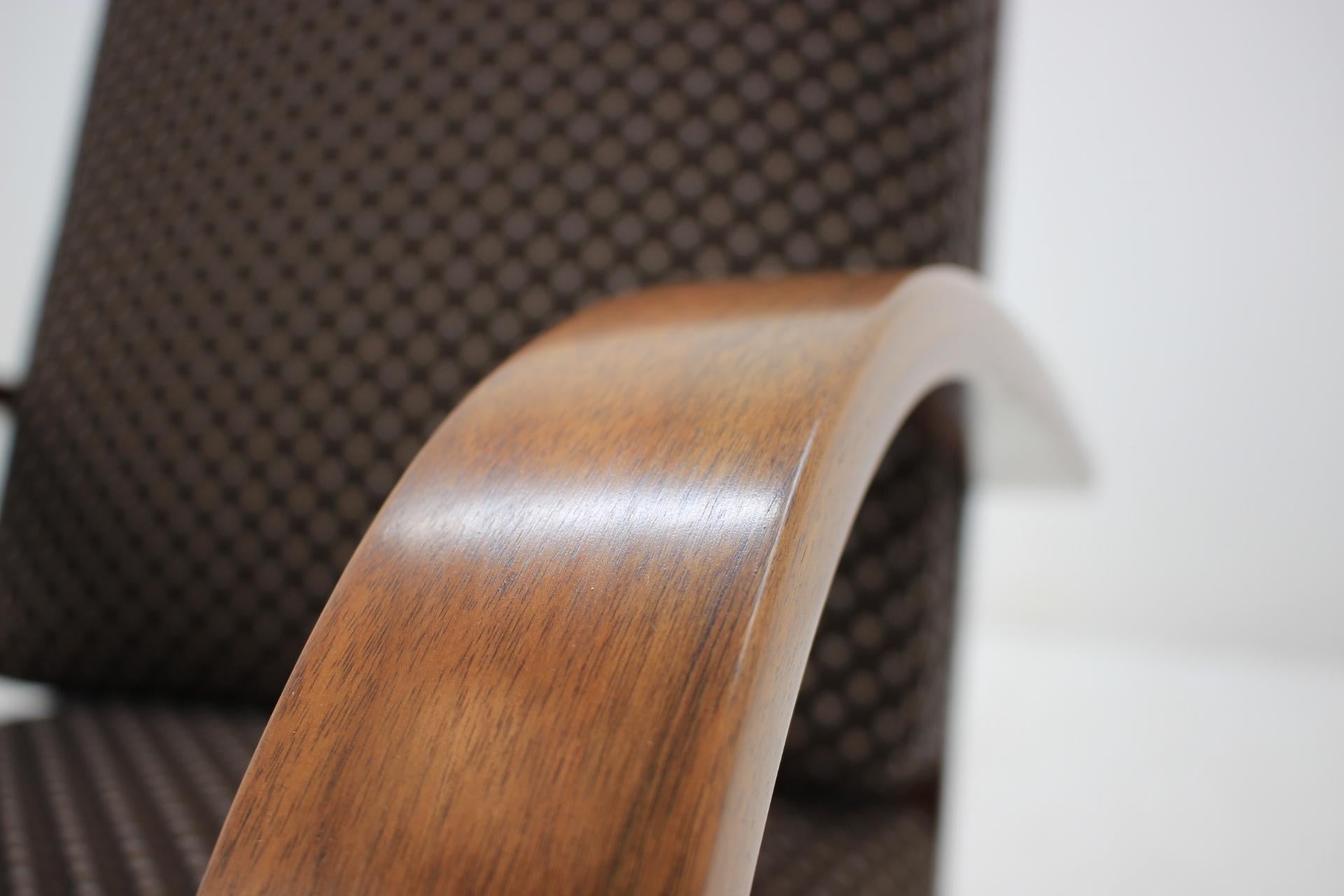 Wooden parts are made of walnut. Original spring cushions with new fabric upholstery. Item was carefully restored.