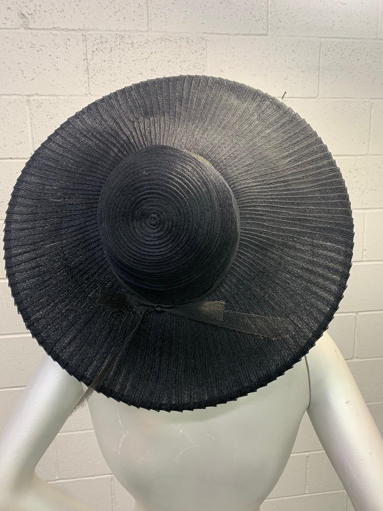 1930s Lilly Dache - Paris black horsehair spiral ribbon cloche hat with wide wired brim. Fits down low and close to the head for a sculpted silhouette. Brim is extravagant and unusual as it is constructed in a fan pattern. An exquisite hat from a