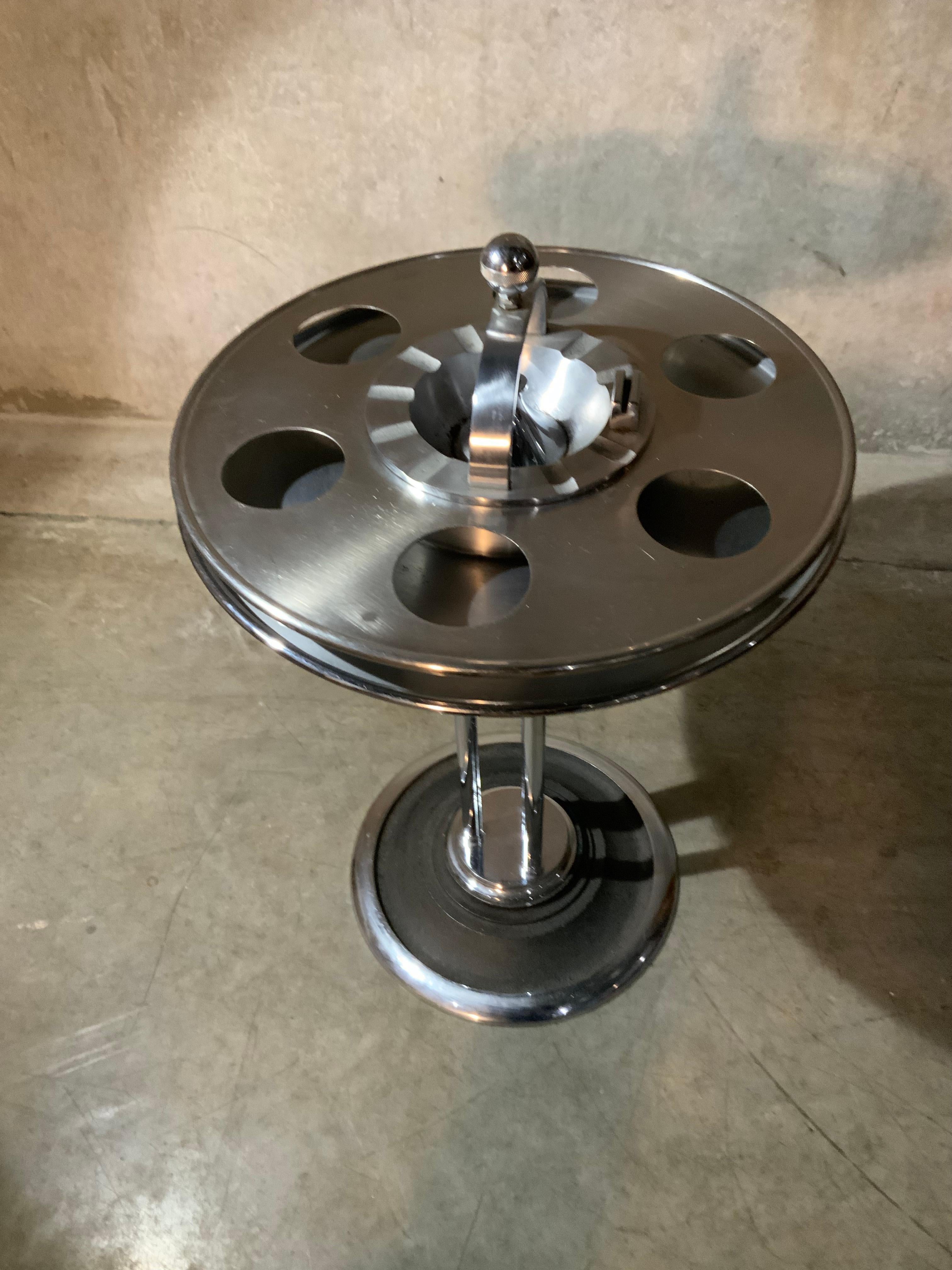 A great Art Deco streamline ash stand from a trains bar car with outer drink tray and match holder. Nickel-plated with satin black details and strong styling from the period, manufactured by W.J. Campbell Machine Company, Indianapolis, IN.

W.J.