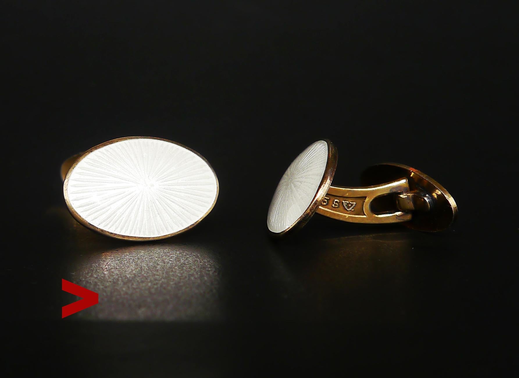 Norwegian cuff-links by J. Tostrup, Art Deco Style and Period.

Gilt Silver and enamel. Both sides show a Bursting Star pattern in White Guilloche Enamel that flashes in any light.

Hallmarked with J. Tostrup logo, 925S, Norway Sterling.

Period of