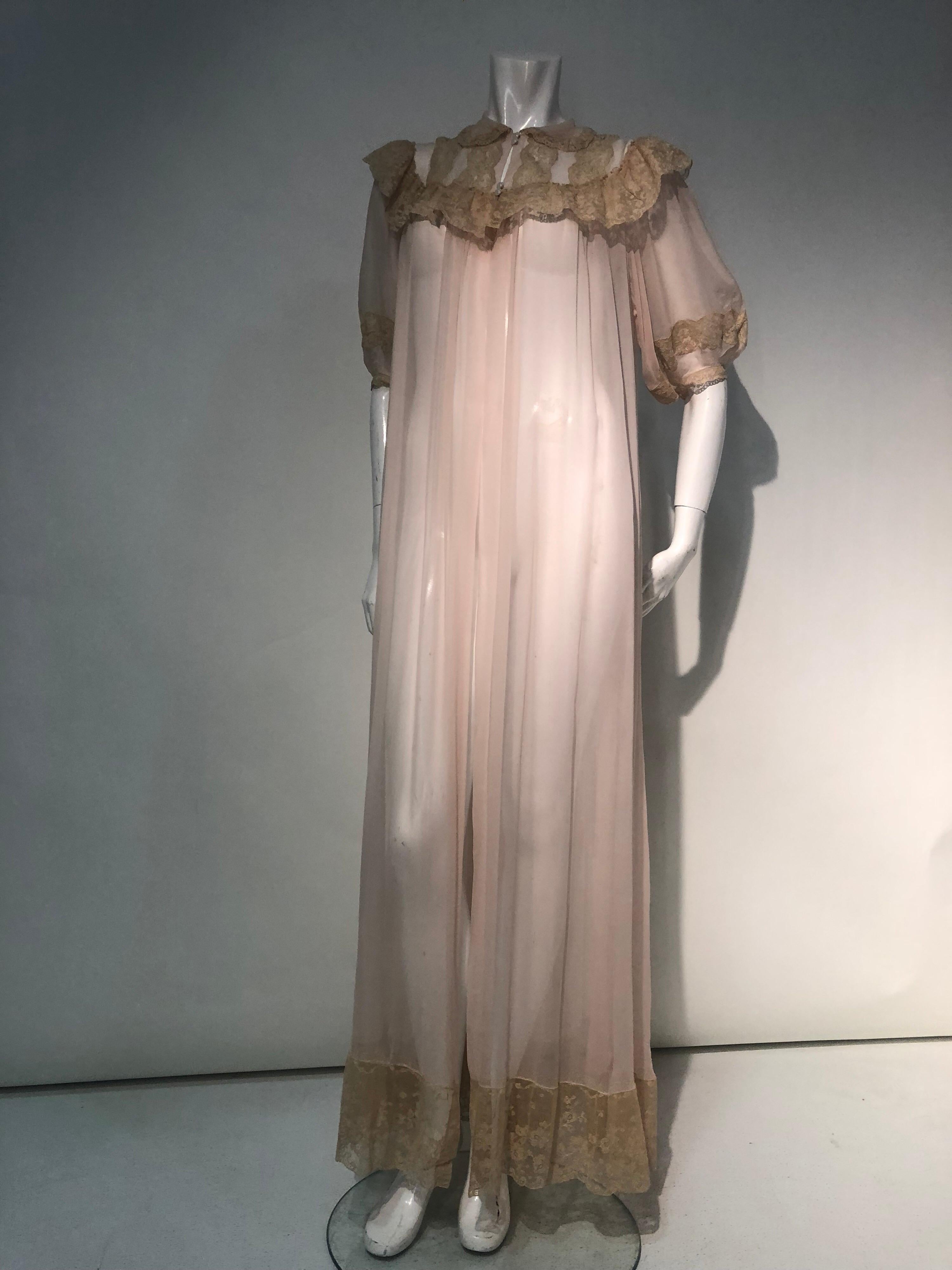A beautiful, romantic 1930s pale pink silk chiffon peignoir:  a very full sweep of chiffon adds drama, while the silk lace ruffle embellished decollétage, mother of pearl buttons and short puffed sleeves lend an air of the Ingénue to this lovely
